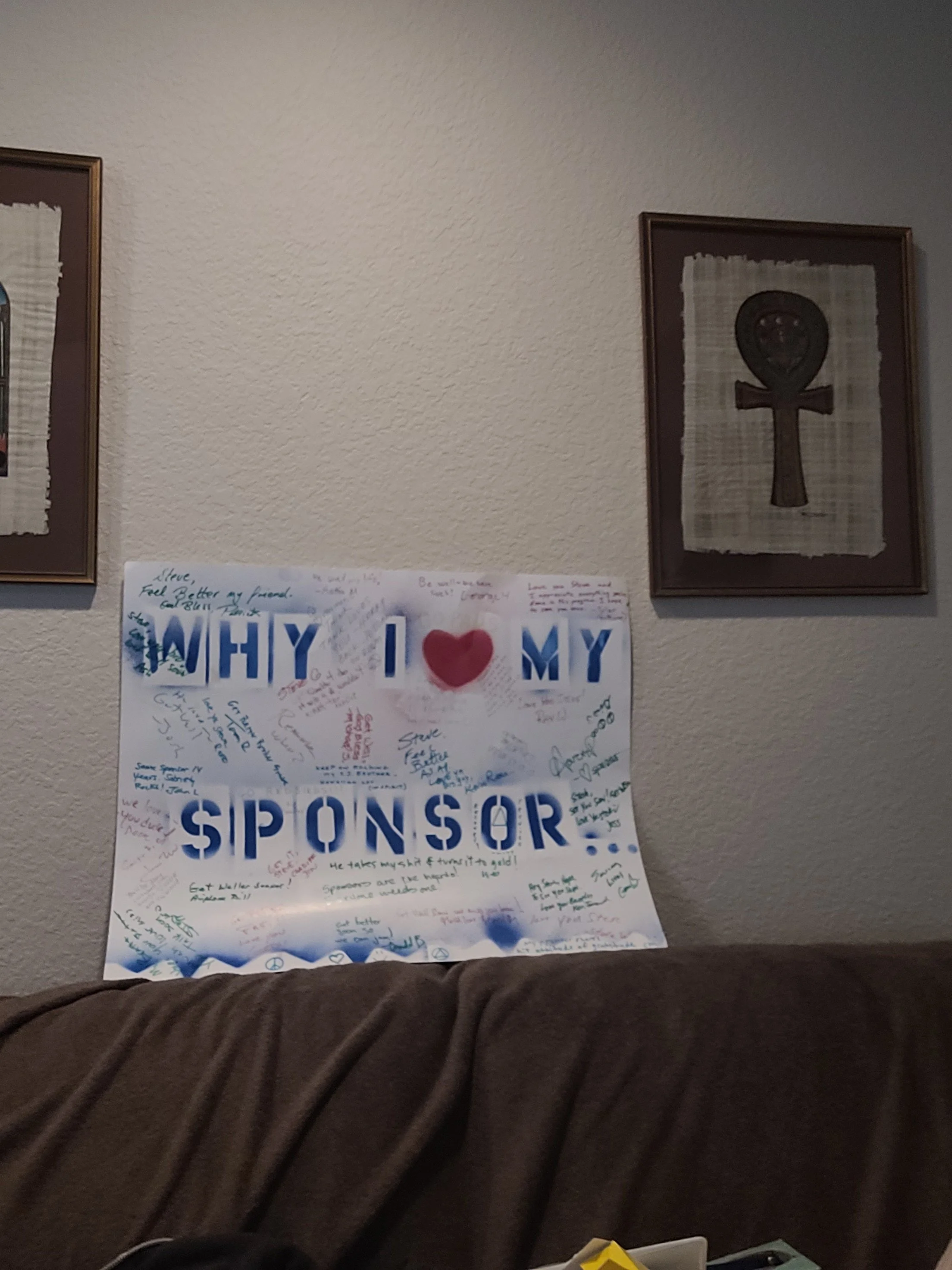 A poster on a wall with various handwritten messages surrounding the words 'WHY I ♥ MY SPONSOR'.