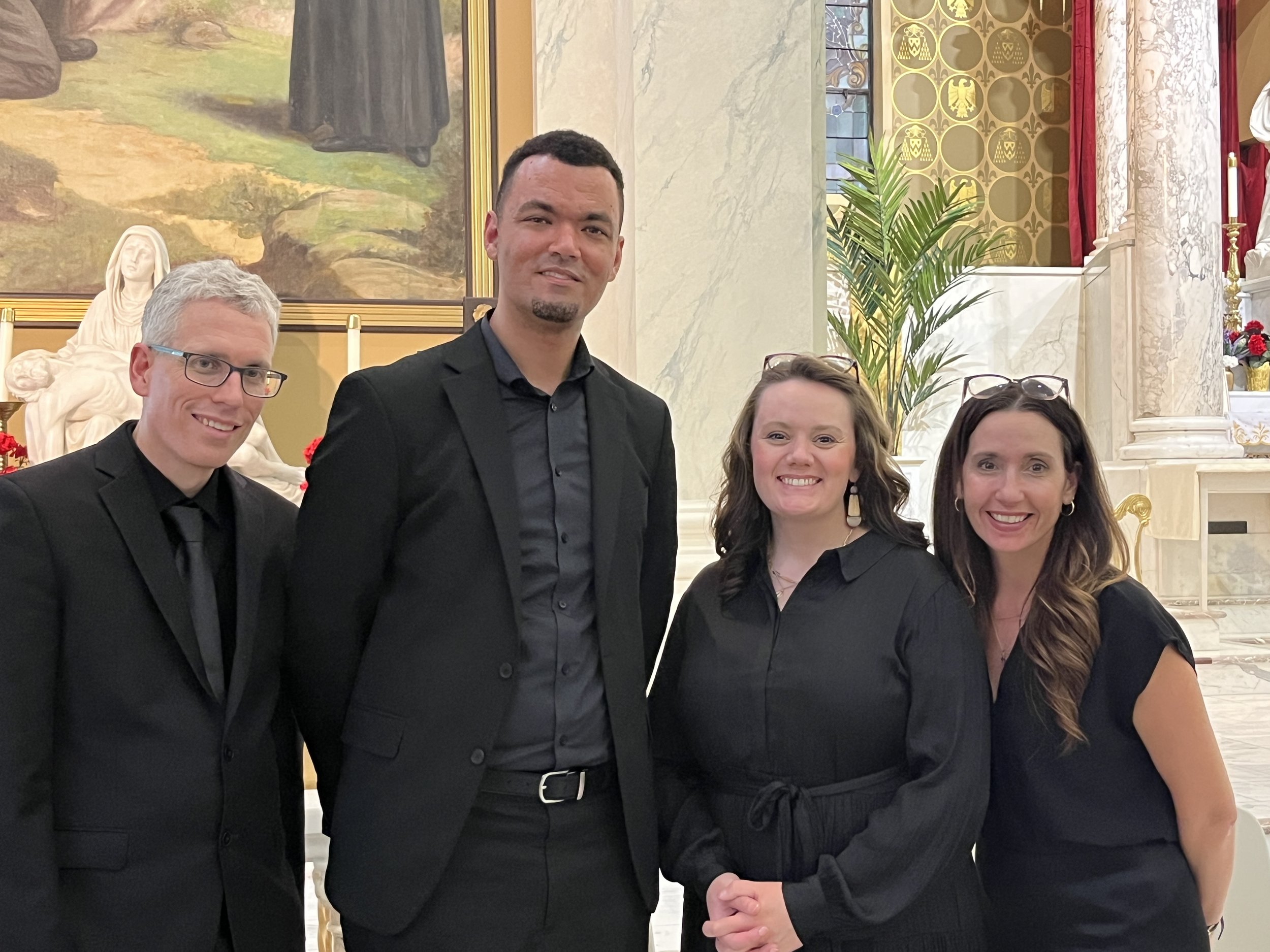 4 singers dressed in black for a concert