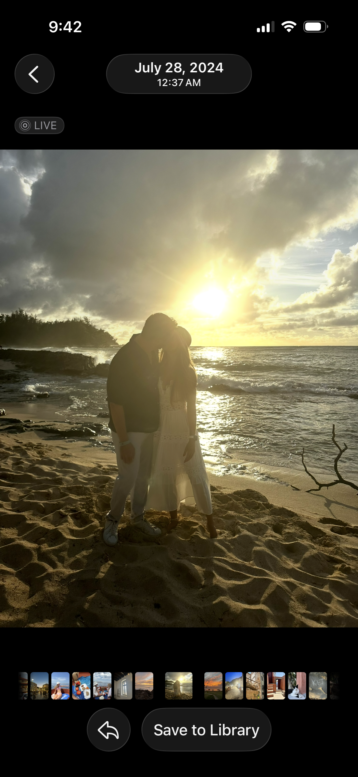 A couple kissing on the beach during sunset, with the sky partly cloudy and the ocean in the background.