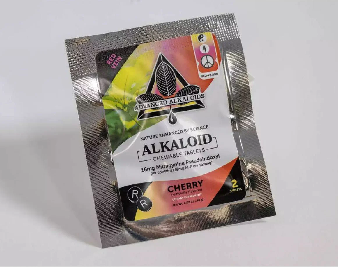 A package of Advanced Alkaloids chewelble tablets, cherry flavored, with two tablets inside, containing 16mg Mitragynine Pseudoindoxyl, designed for relaxation.