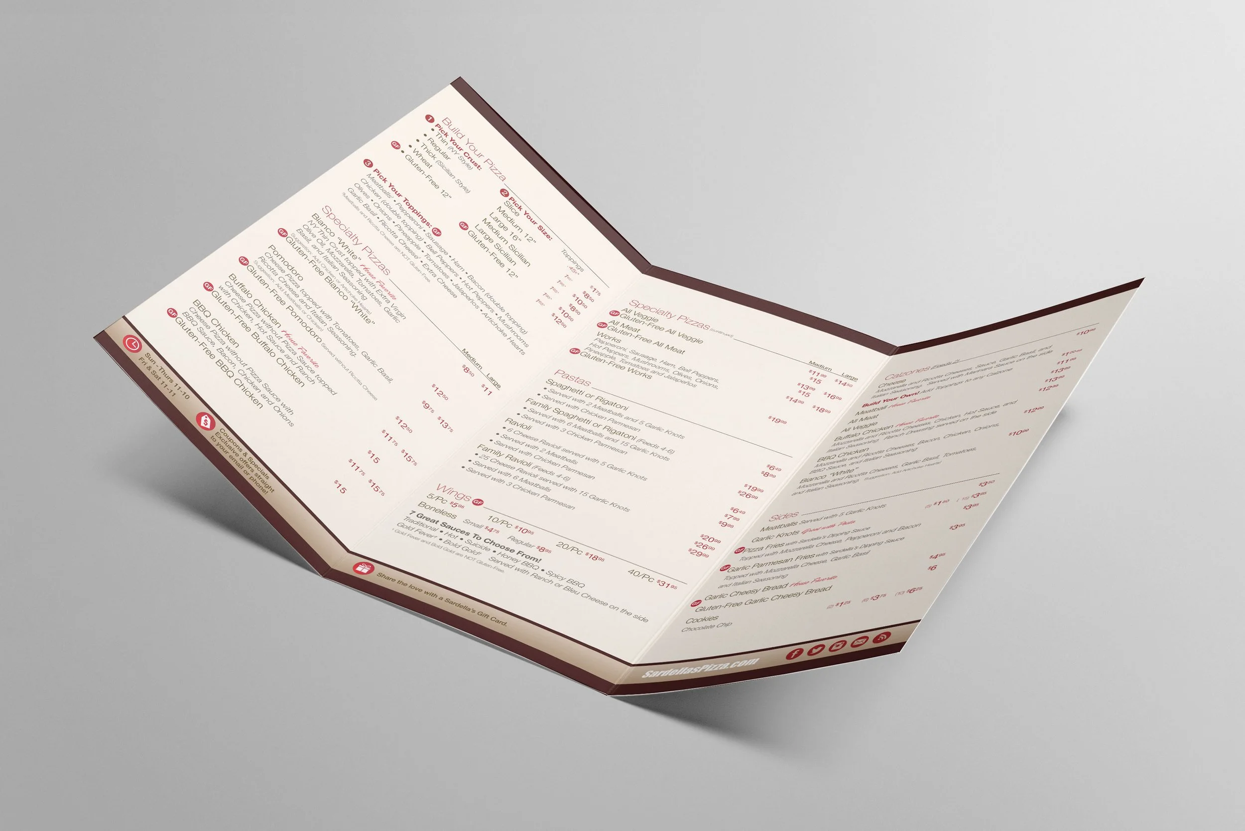 A folded pizza restaurant menu on a grey surface.