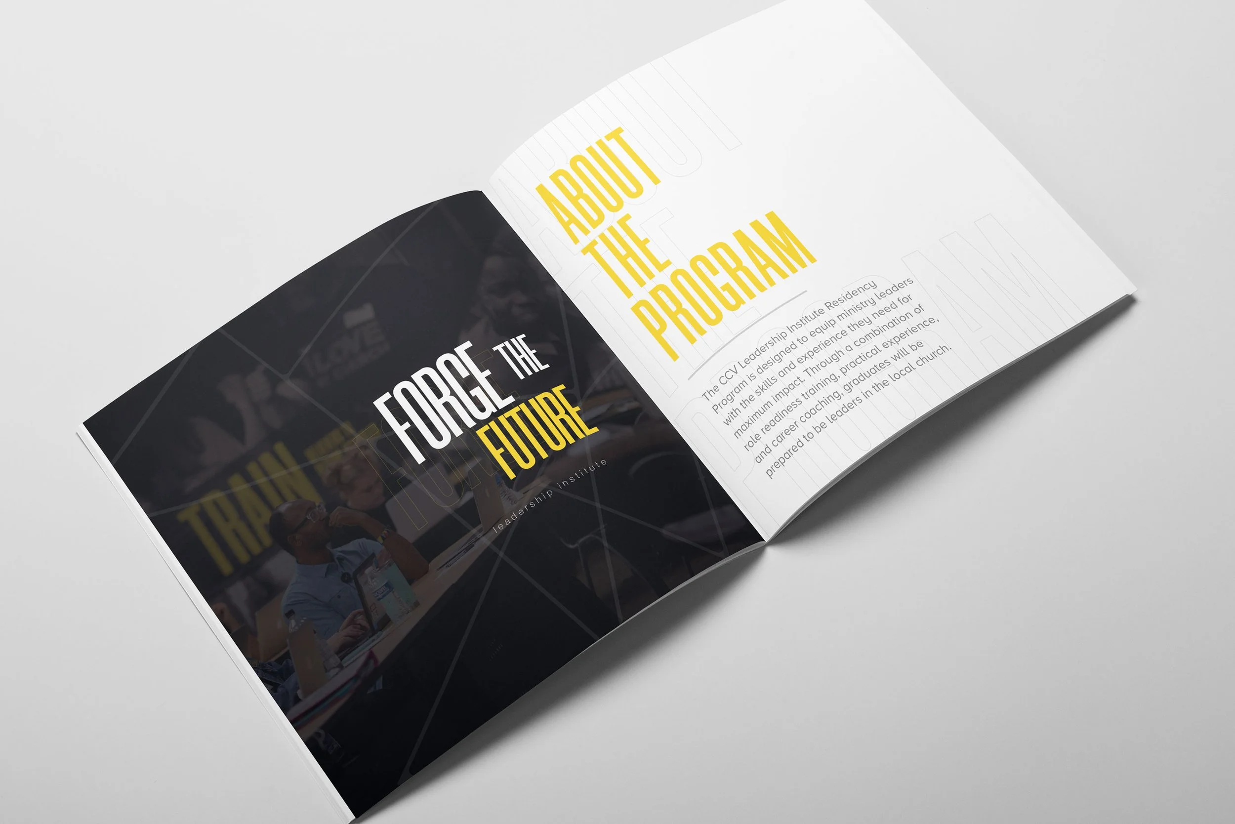 Open booklet with title "About the Program" in yellow text, featuring a black section with the title "Forge the Future" and an image of a speaker at a conference table.