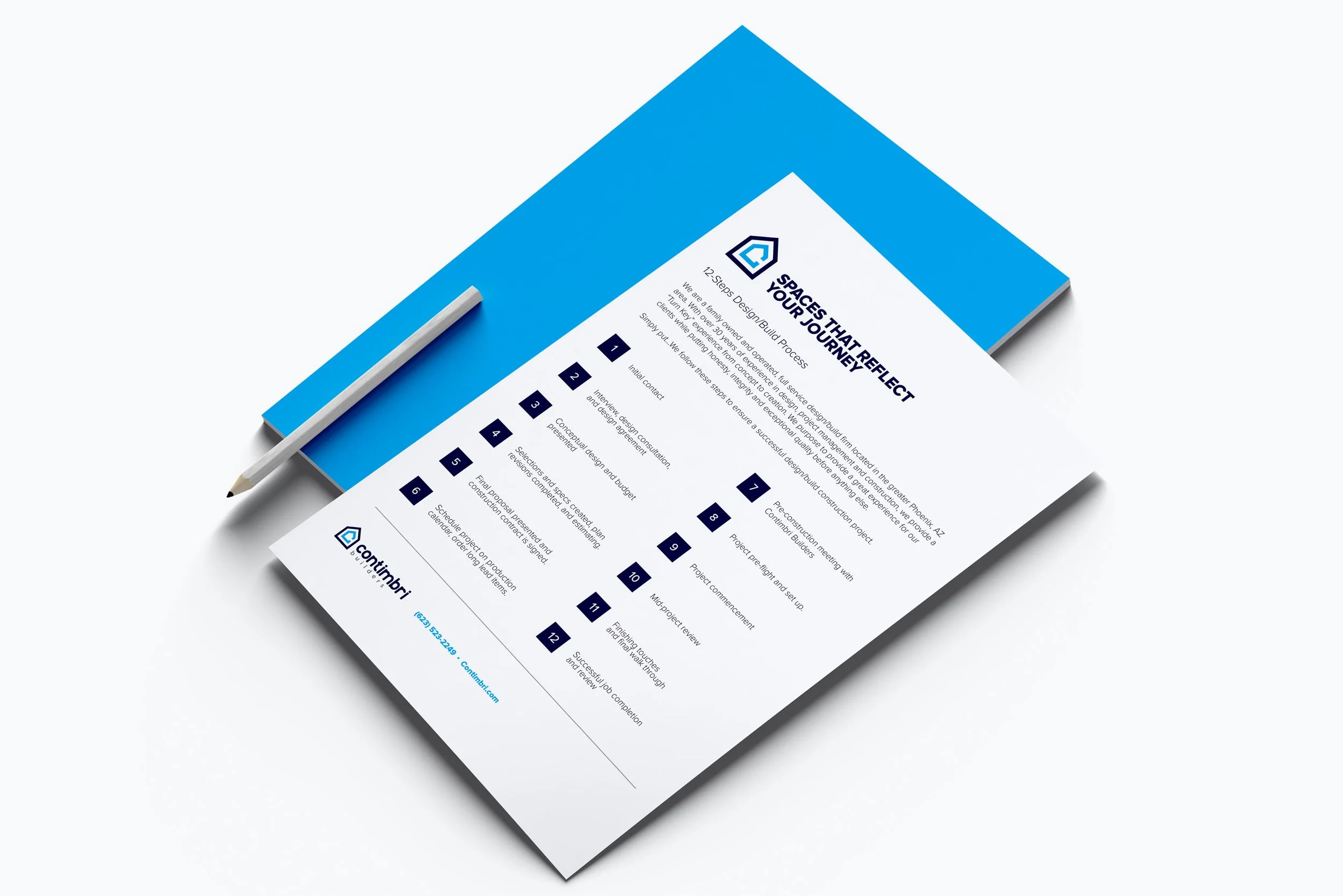 A printed project plan or brochure with a blue and white color scheme, placed on a white surface, accompanied by a white pen.