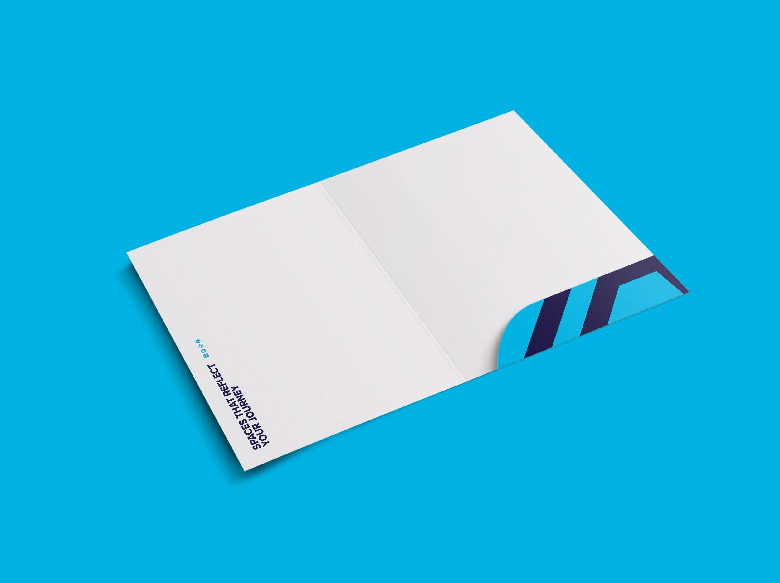 Open booklet or brochure on a bright blue background, partially visible, with some text and geometric shapes on its pages.