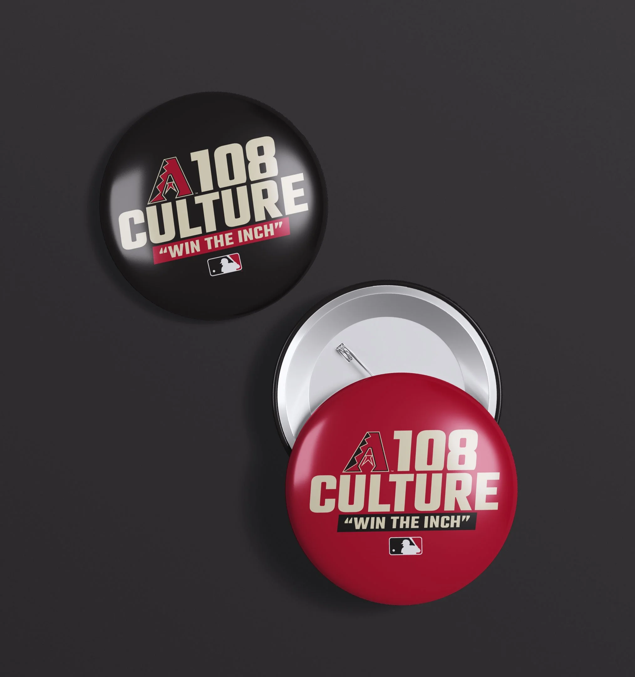 Close-up of a pin with the Arizona Diamondbacks logo and text '108 CULTURE' and ''WIN THE INCH' on a black background.
