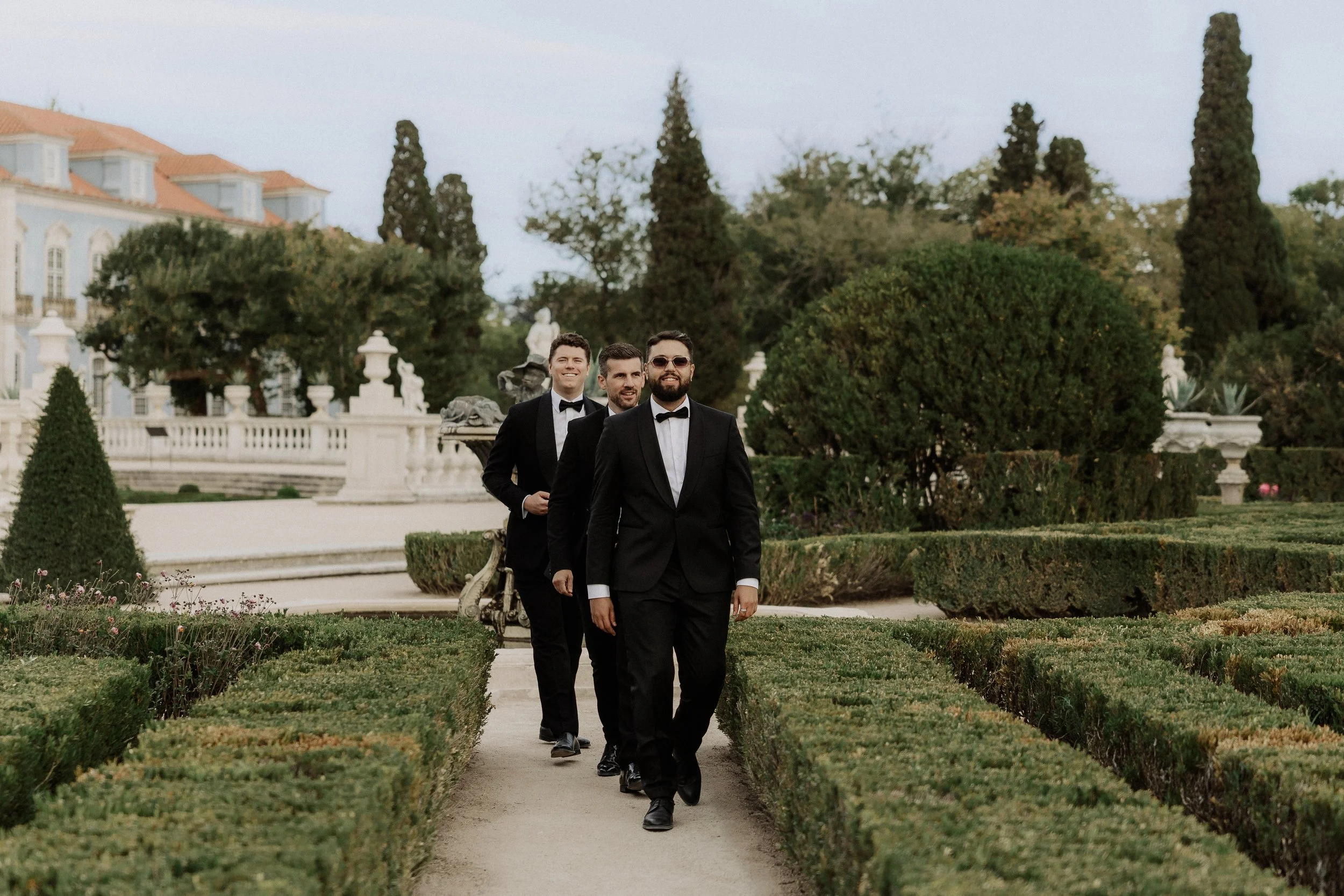  Wedding guests walking and enjoying the gardens at Palace of Queluz, Sintra, Portugal, photographed by Cátia Soares 