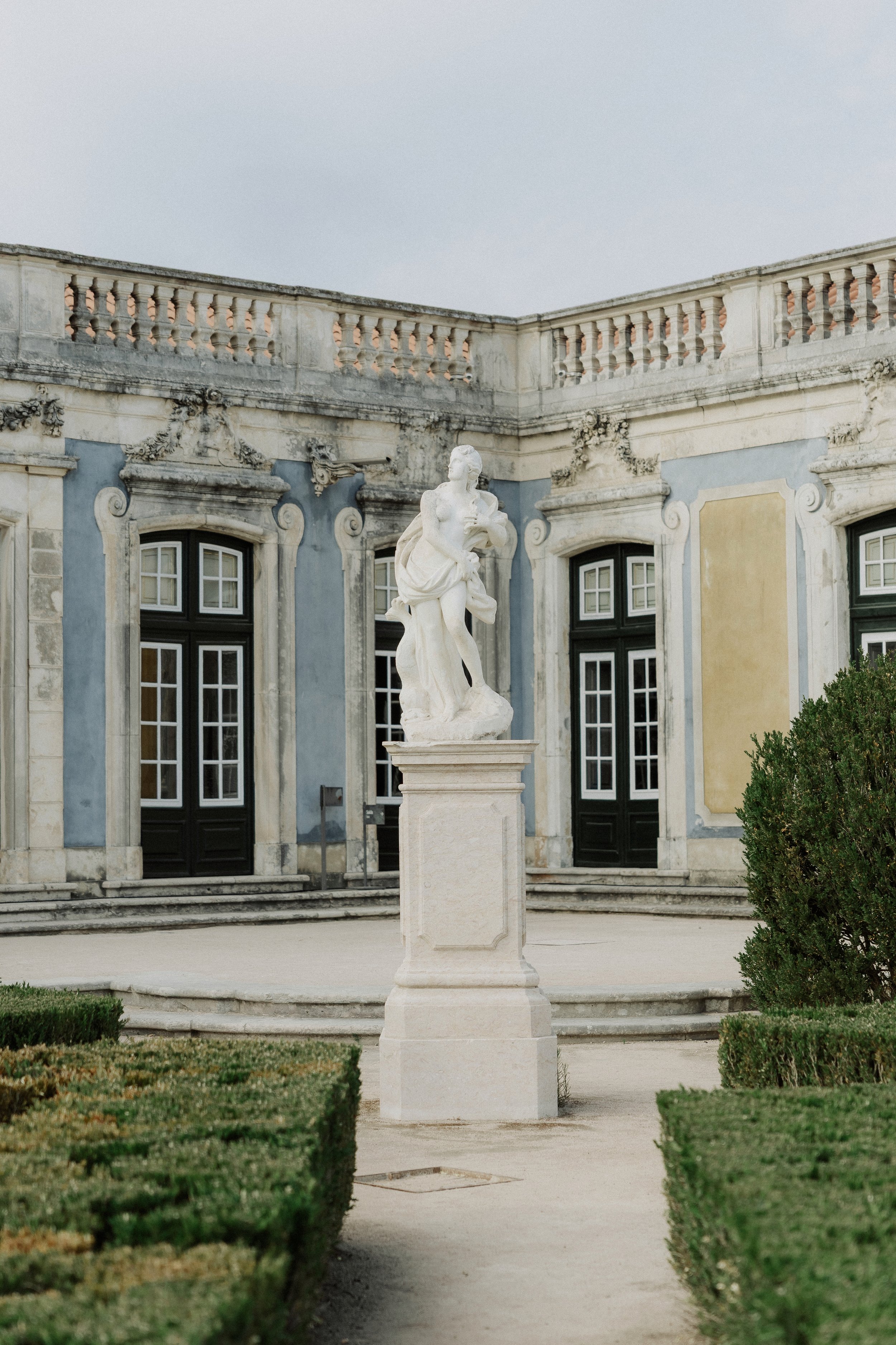 Historic statue in the gardens of the Palace of Queluz, a luxury wedding venue near Lisbon 