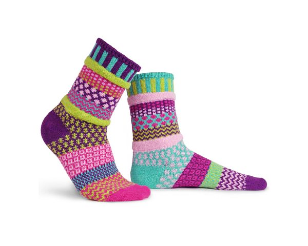 A pair of multi-colored socks in various patterns all over the socks