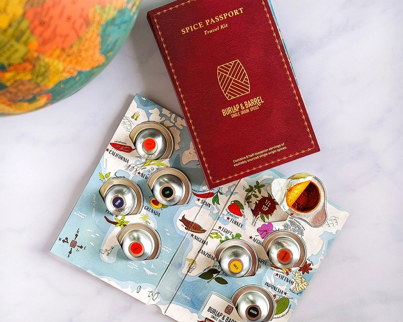 A small booklet of little spice packages and a red package that reads "Spice Passport"