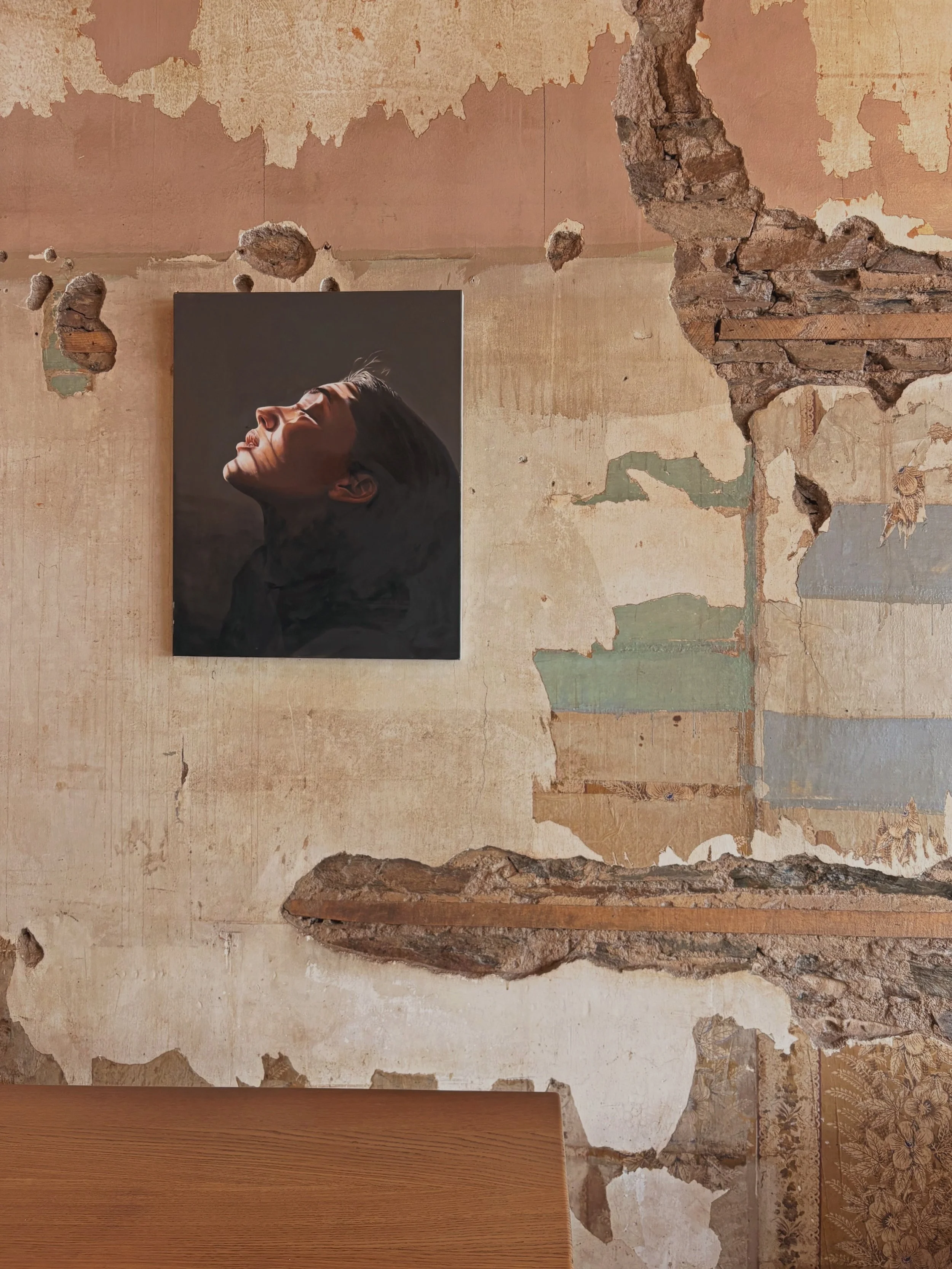 Worn wall with artwork.