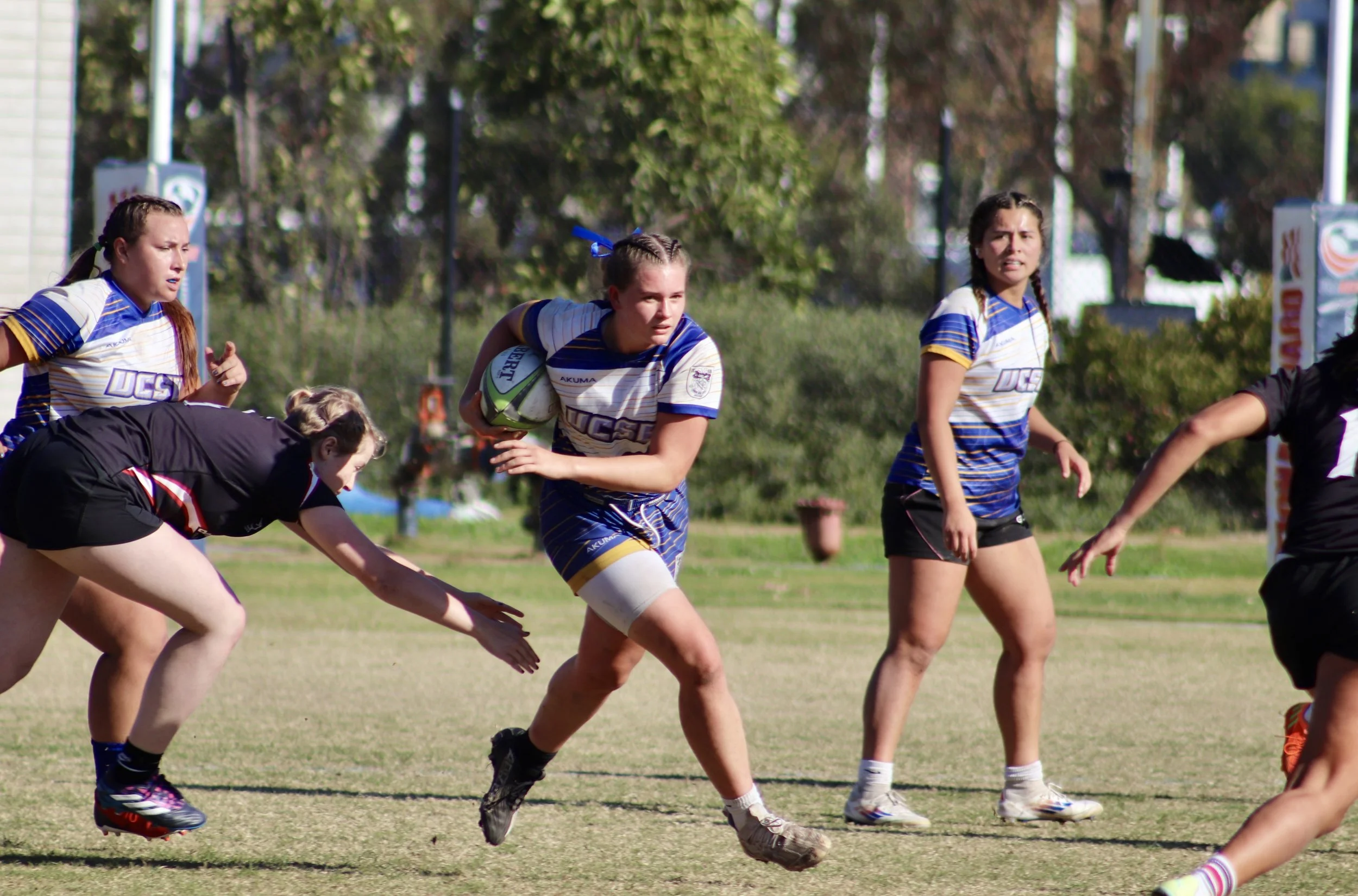 My sister running with the rugby ball at a UCSB Rugby game.
