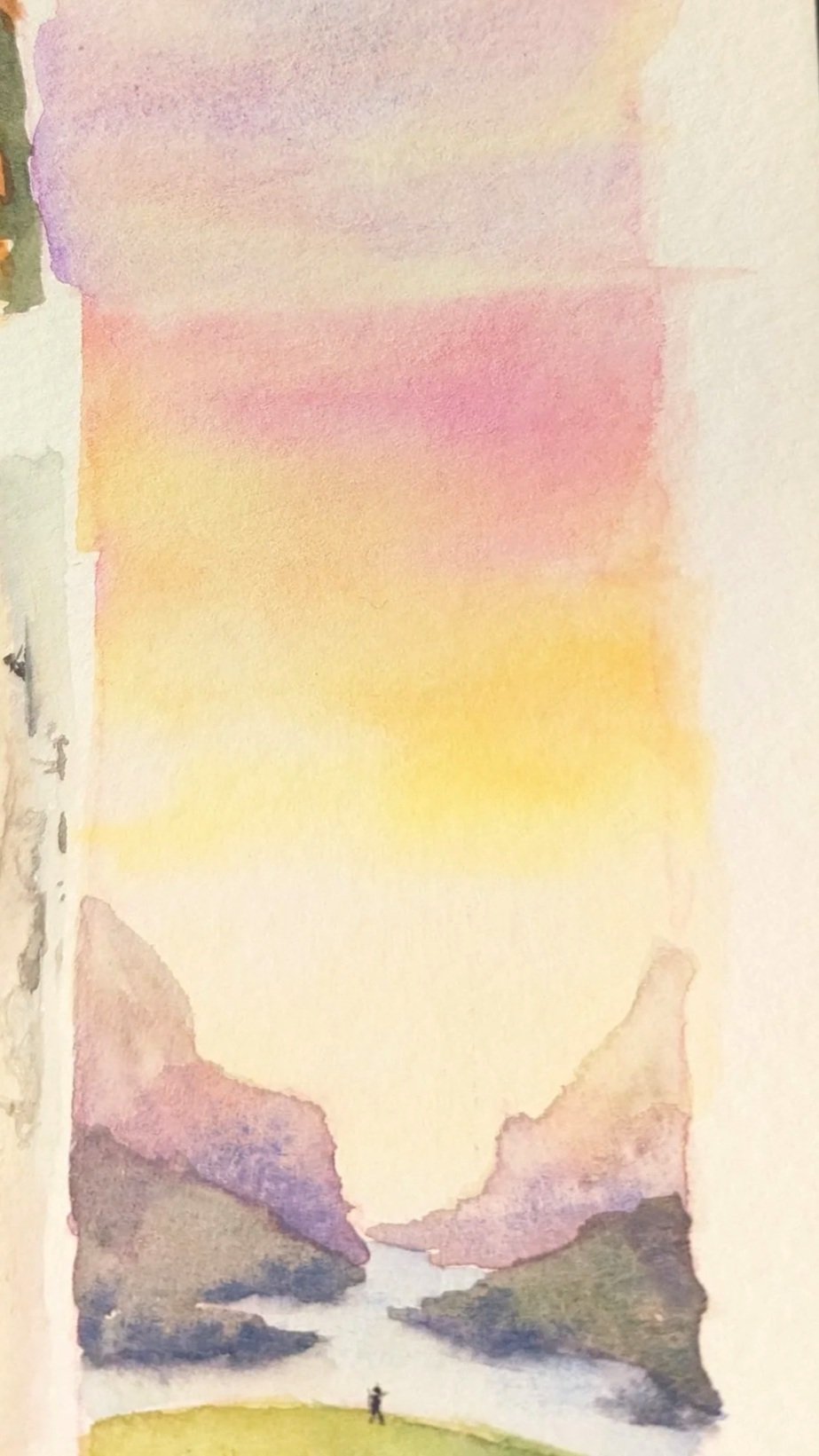 A watercolor landscape painting of a person standing on a green hill, with mountains, a river, and a colorful sky with pink, purple, yellow, and orange hues.