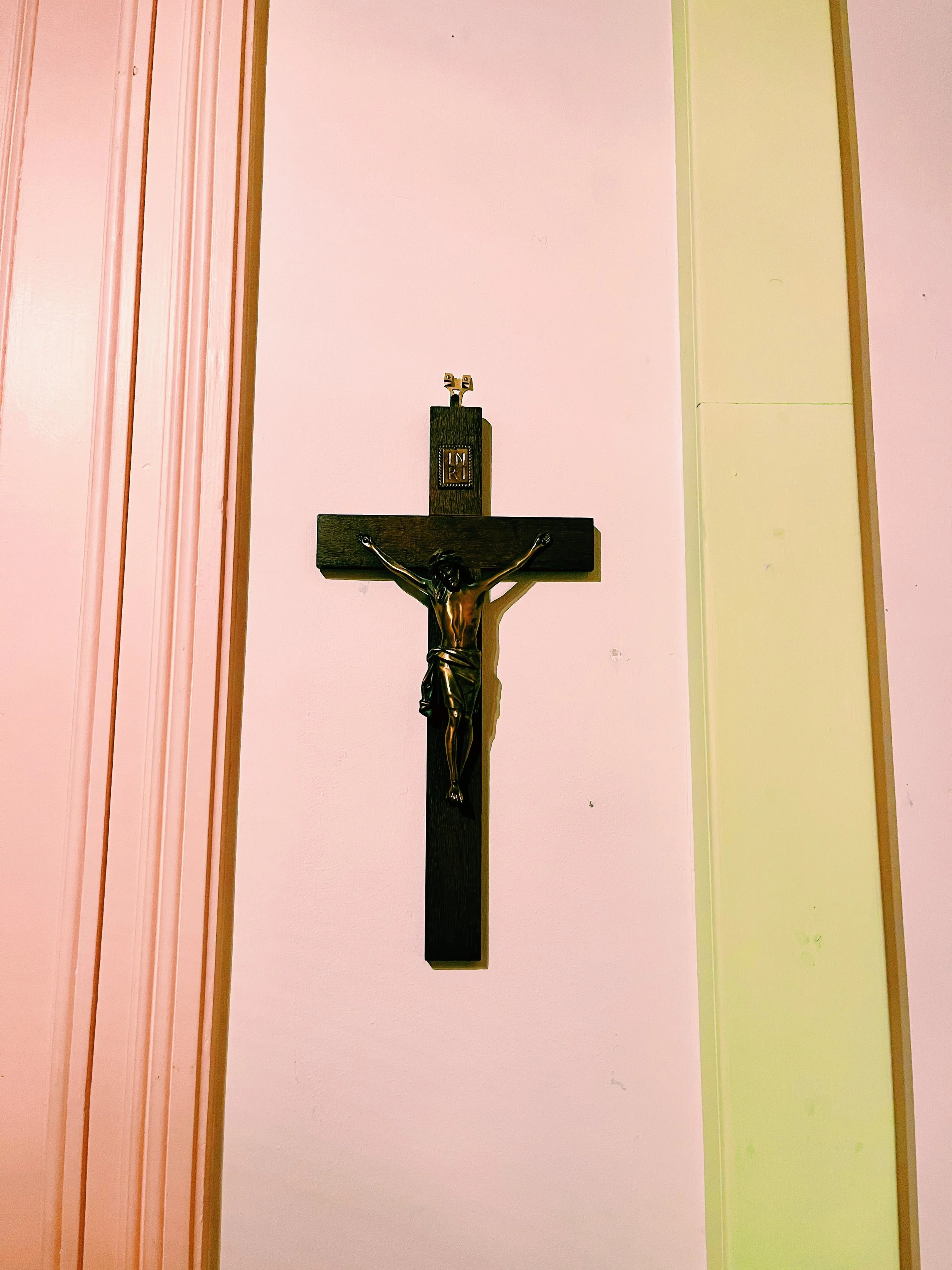 bedroom-crucifix-on-pink-wall-religious-iconography-interior-photography.jpg.JPEG