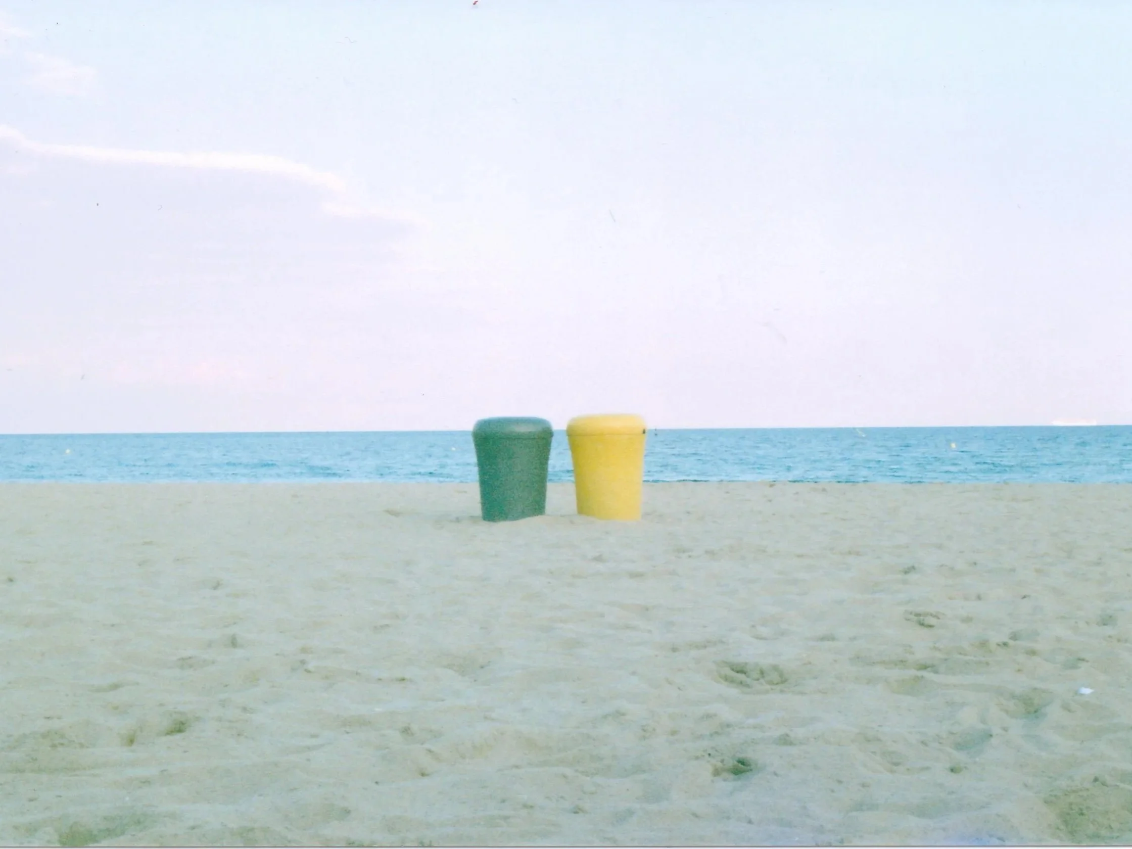 yellow-and-green-bins-on-empty-beach-barcelona.jpg.jpg