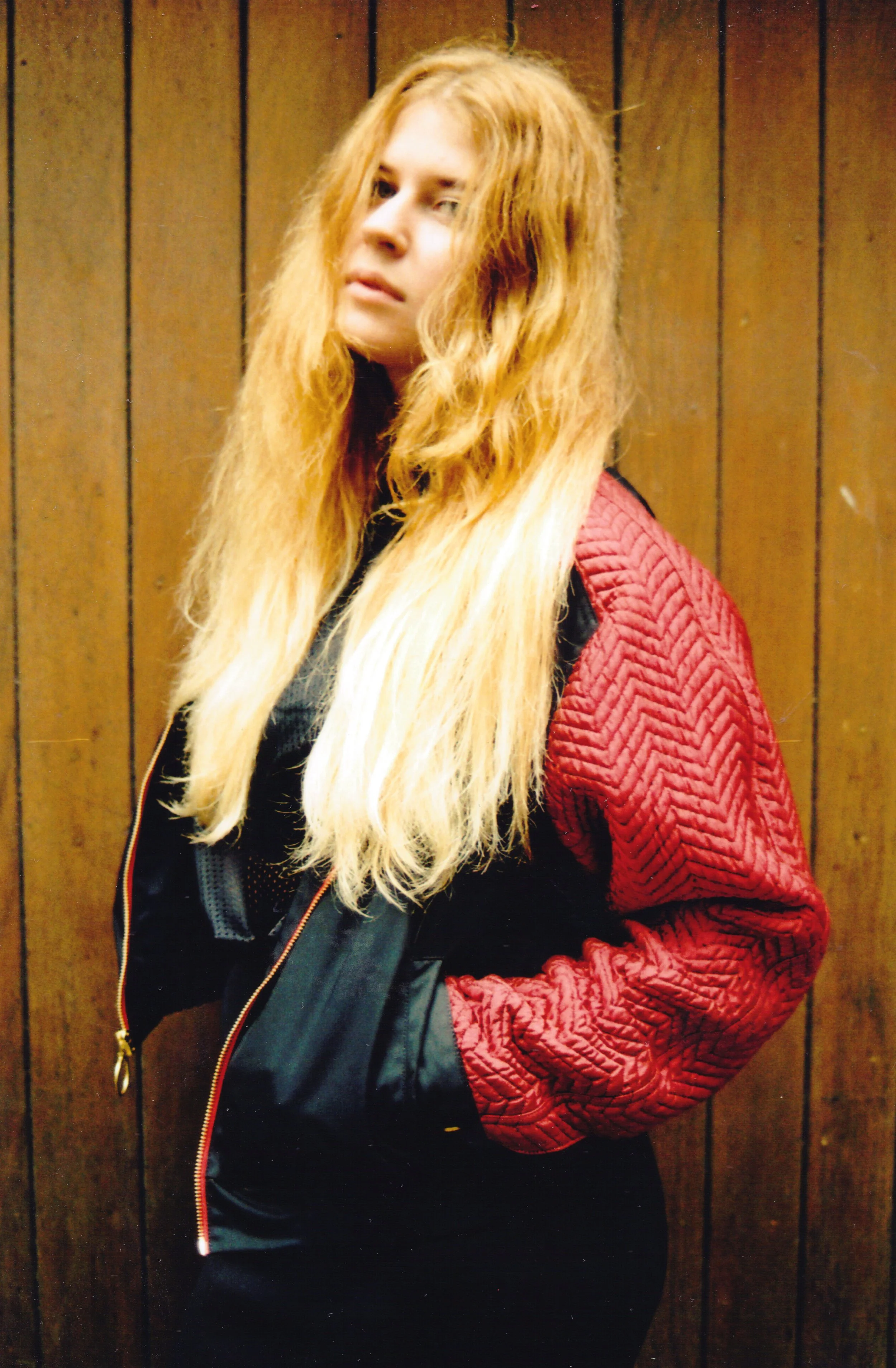 woman-in-red-and-black-jacket-standing-against-wooden-wall.jpg.jpg