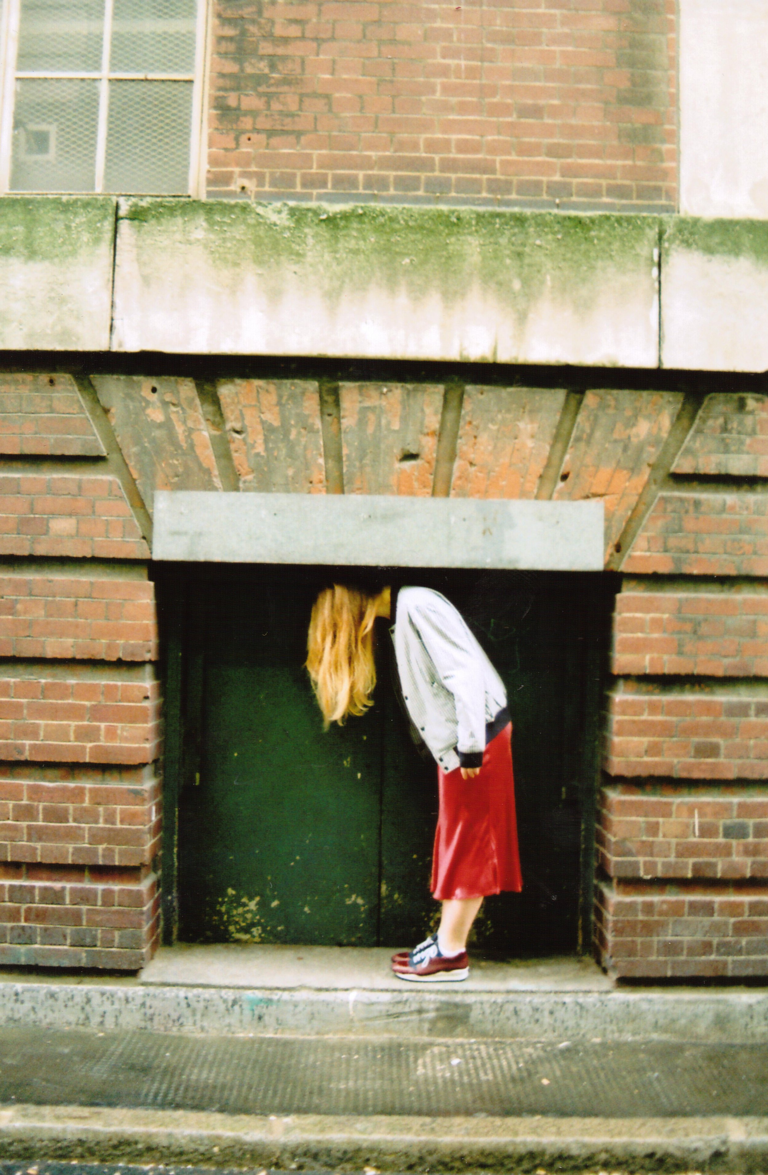 woman-in-red-skirt-bending-under-arched-building-wall.jpg.jpg