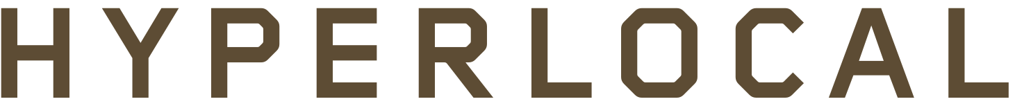 Close-up of black text that reads 'HYPERLOCAL' on a brown background.