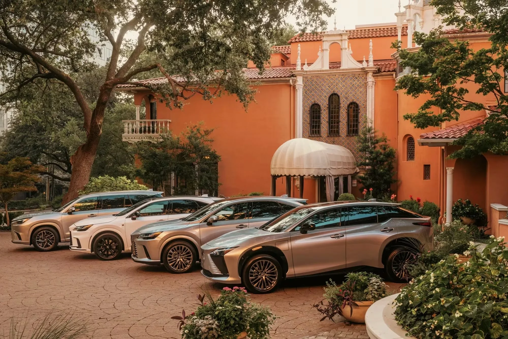 A close-up view of a vintage Toyota Land Cruiser vehicle with a sticker that says 'HYPER LOCAL' on its door, parked outdoors with trees and sky in the background.