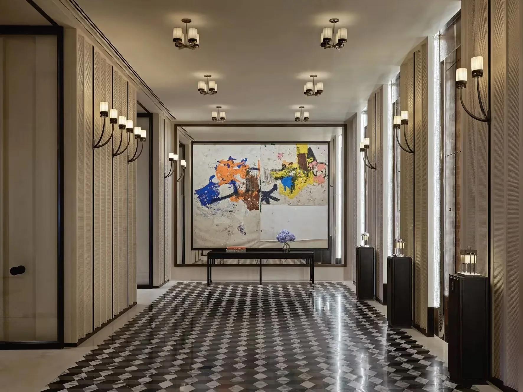 Multiple treehouse-style structures with thatched roofs nestled among trees on a hillside at dusk.