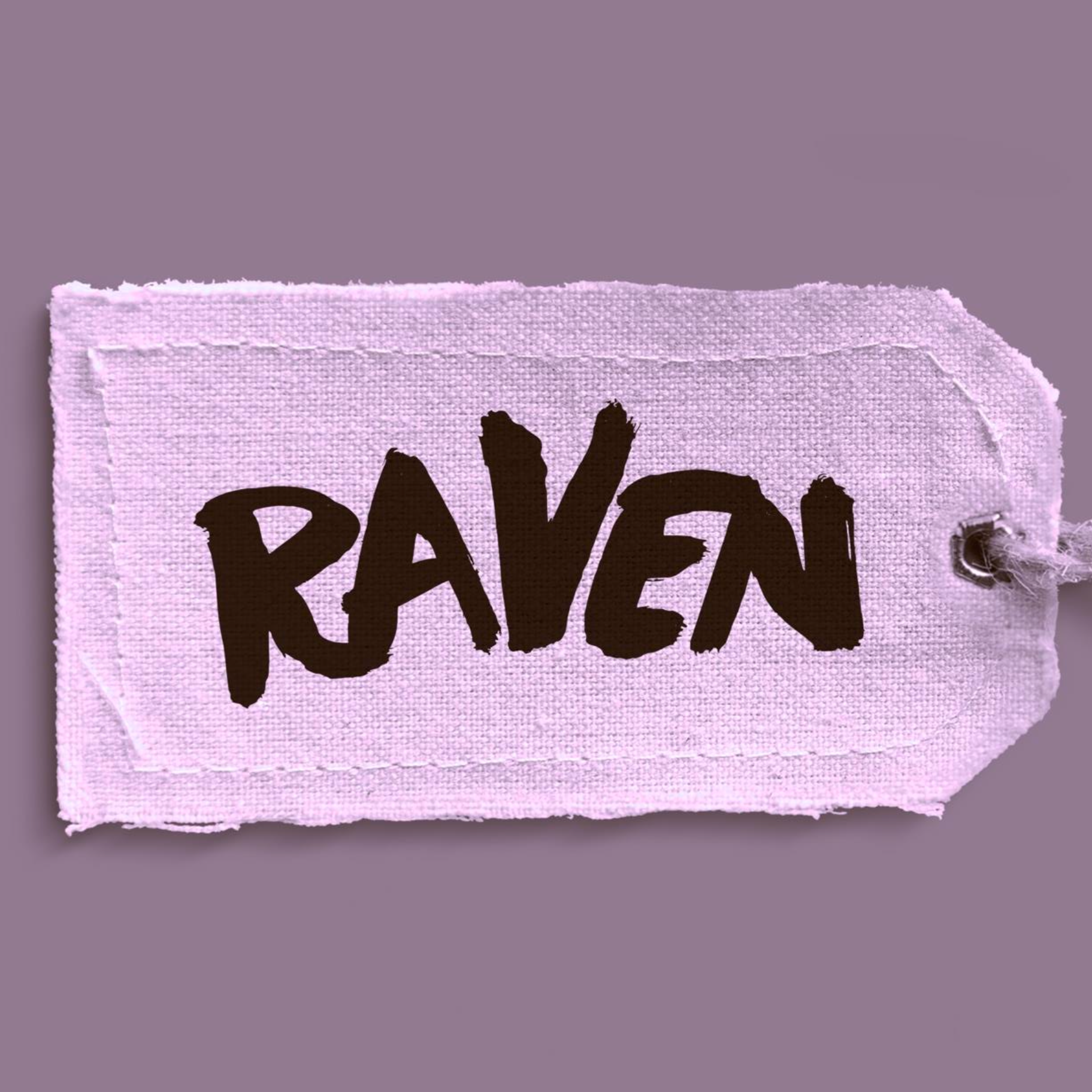 Close-up of a pink fabric label with black handwritten text that appears to spell 'RAVEN' on a purple background.