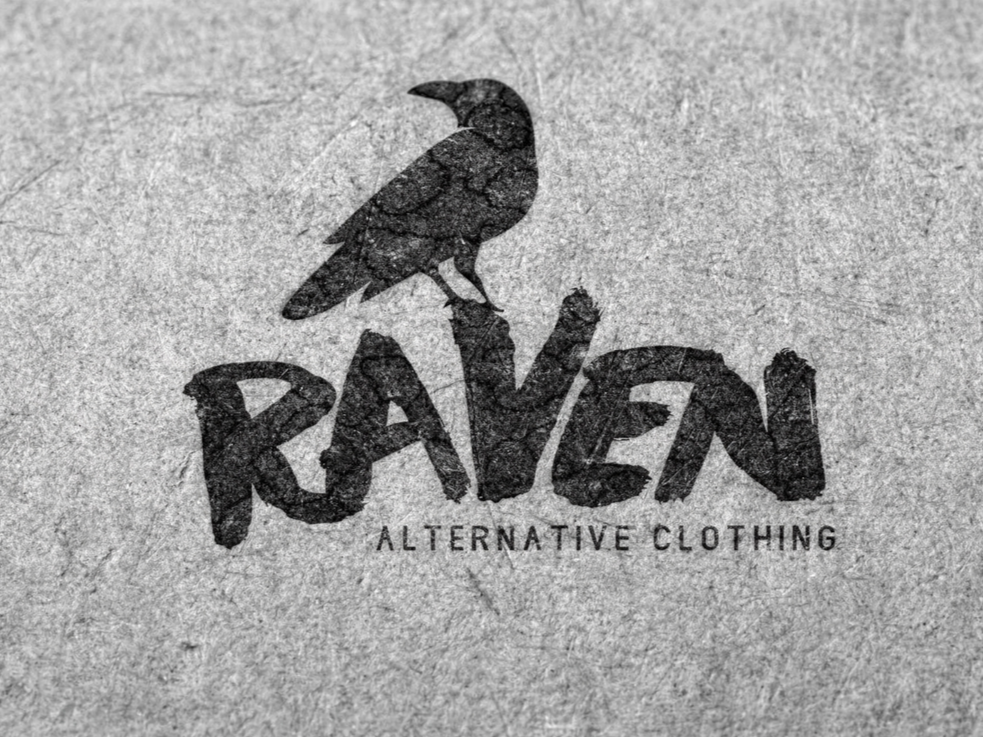 Logo for Raven Alternative Clothing featuring a black silhouette of a raven perched on the word 'RAVEN' written in bold, stylized letters, with the phrase 'ALTERNATIVE CLOTHING' underneath.