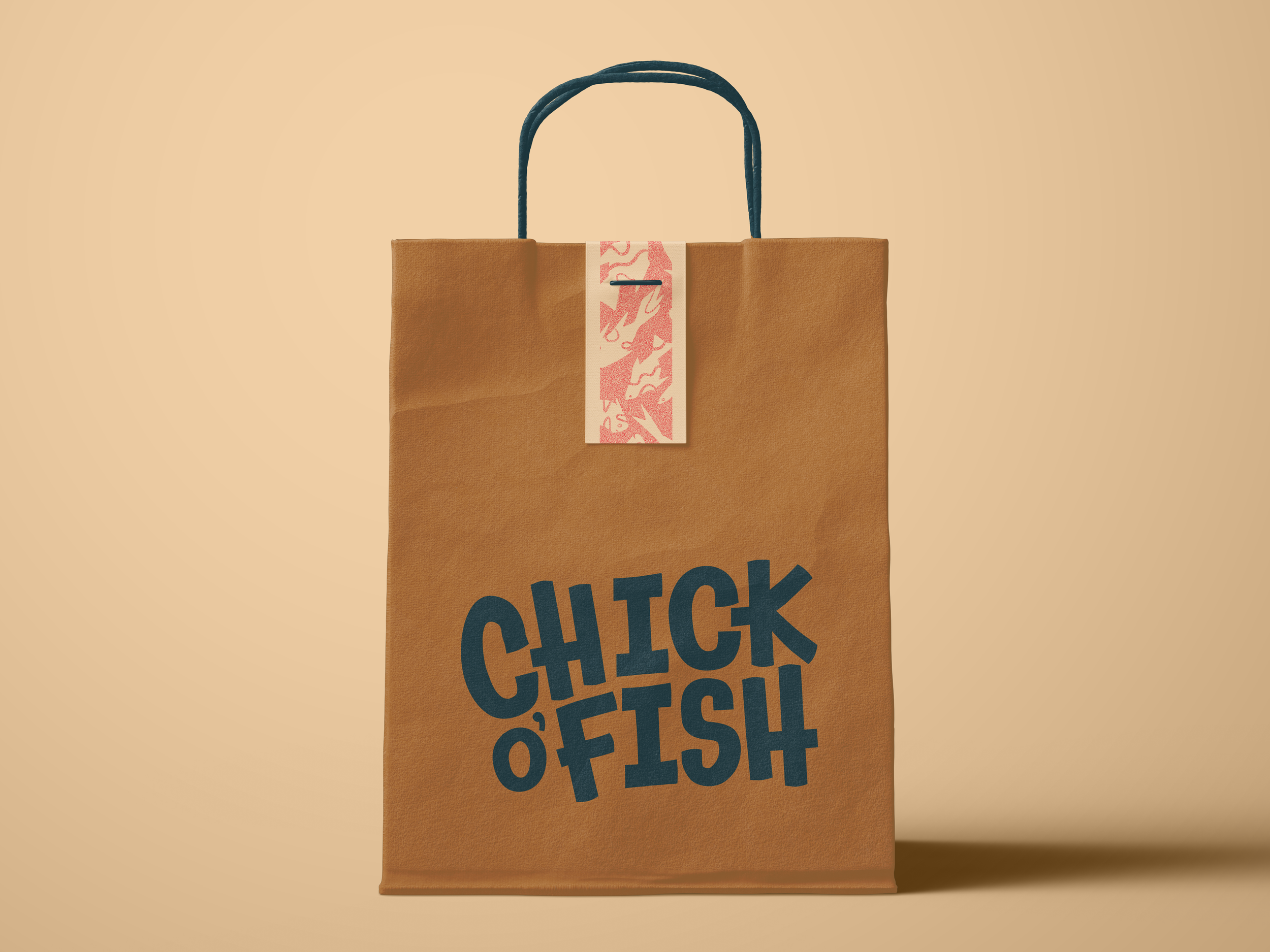 A paper grocery bag with a decorative paper strip attached to the handle, standing against a beige background. The bag has bold, large text in dark blue that reads 'CLICK', but the full text is not visible.