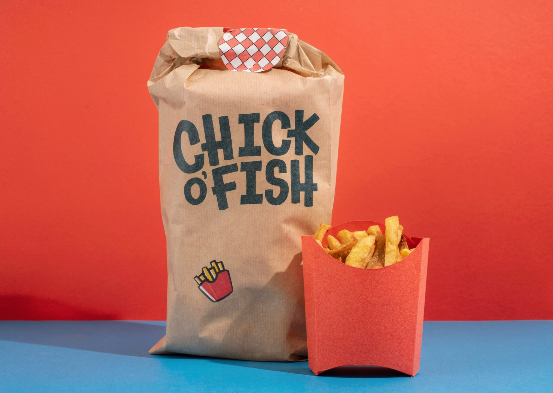 A paper bag with the text 'CHICK' and 'FISH' on it, next to a red container of French fries, set against a colorful background.