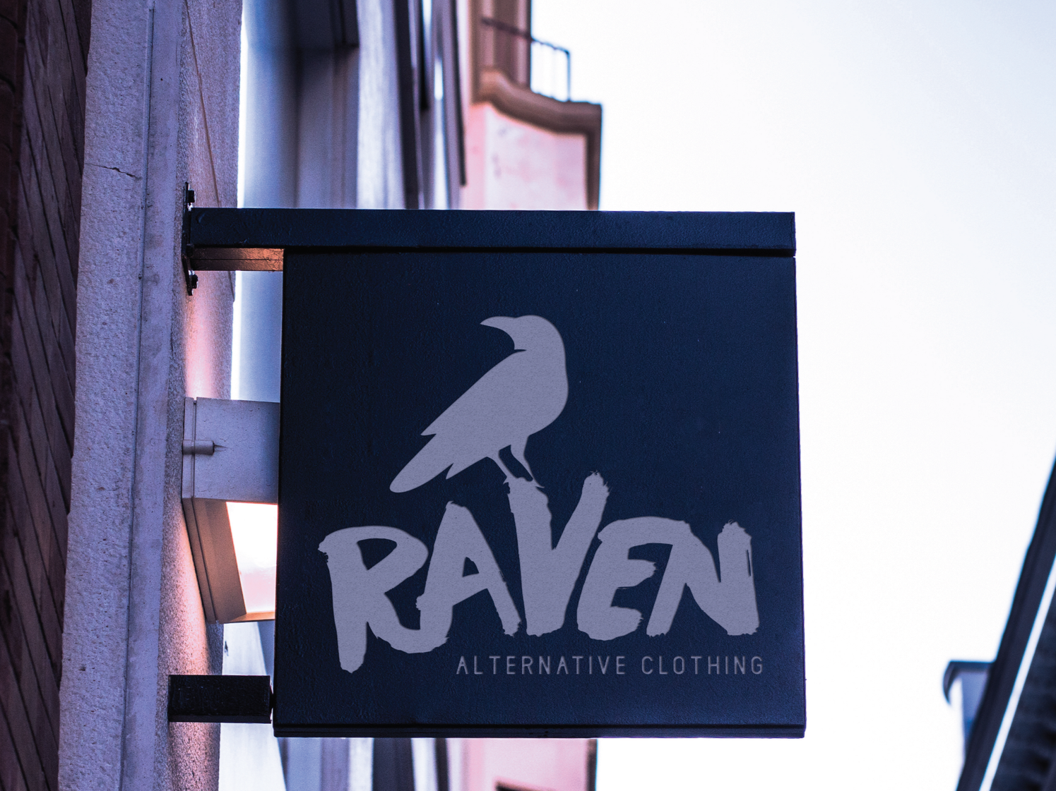 Sign for Raven Alternative Clothing with a raven illustration and white text on a dark background
