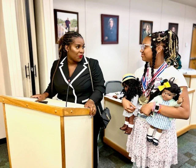A teacher helping students with schoolwork in a classroom.