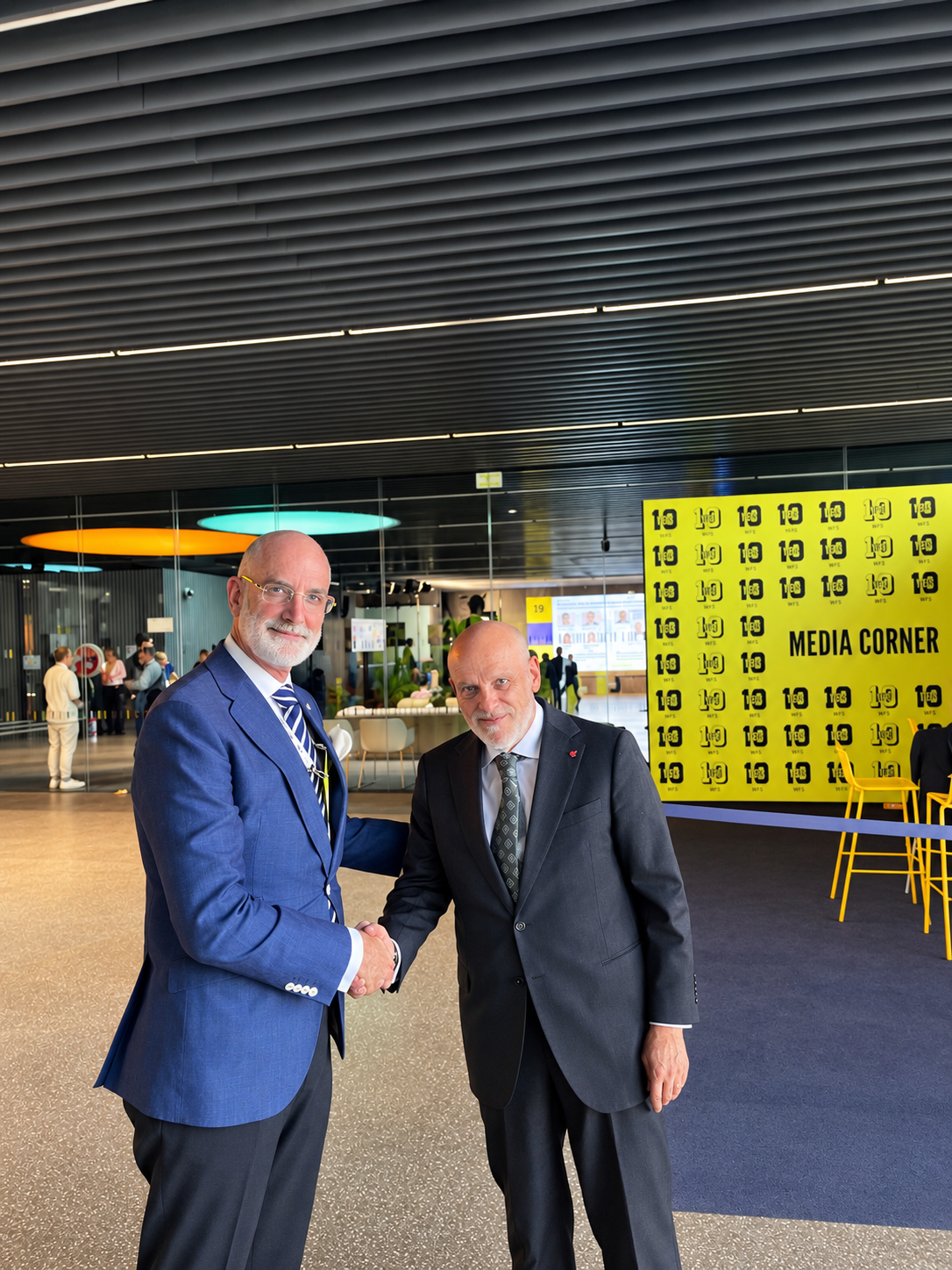 Conference Handshake at Media Corner.png