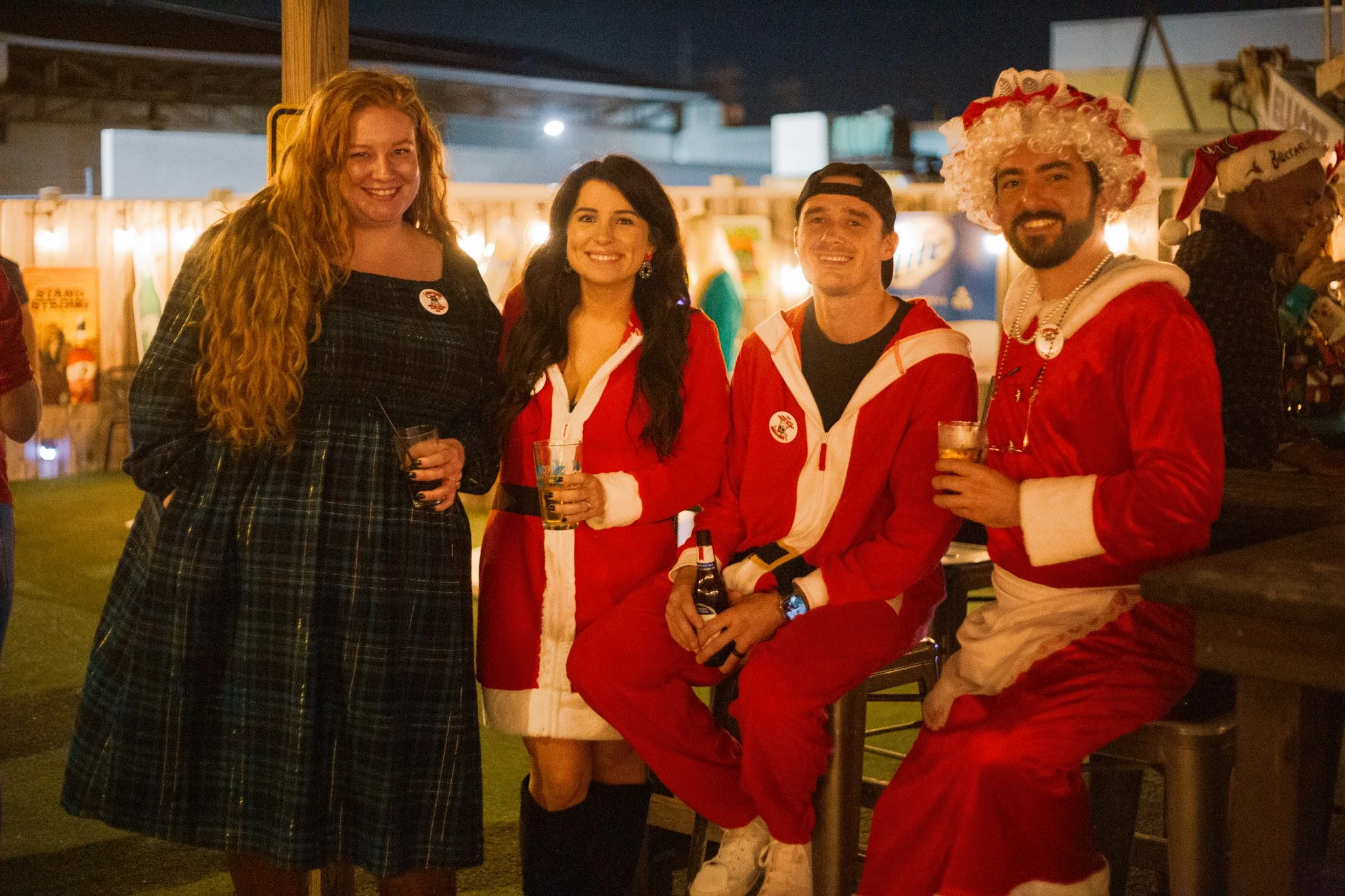 Group of people dressed in Christmas costumes enjoying a festive party at night