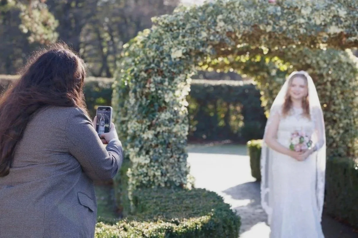 luxury wedding content creator, based in Hertfordshire, taking photo of bride at wedding