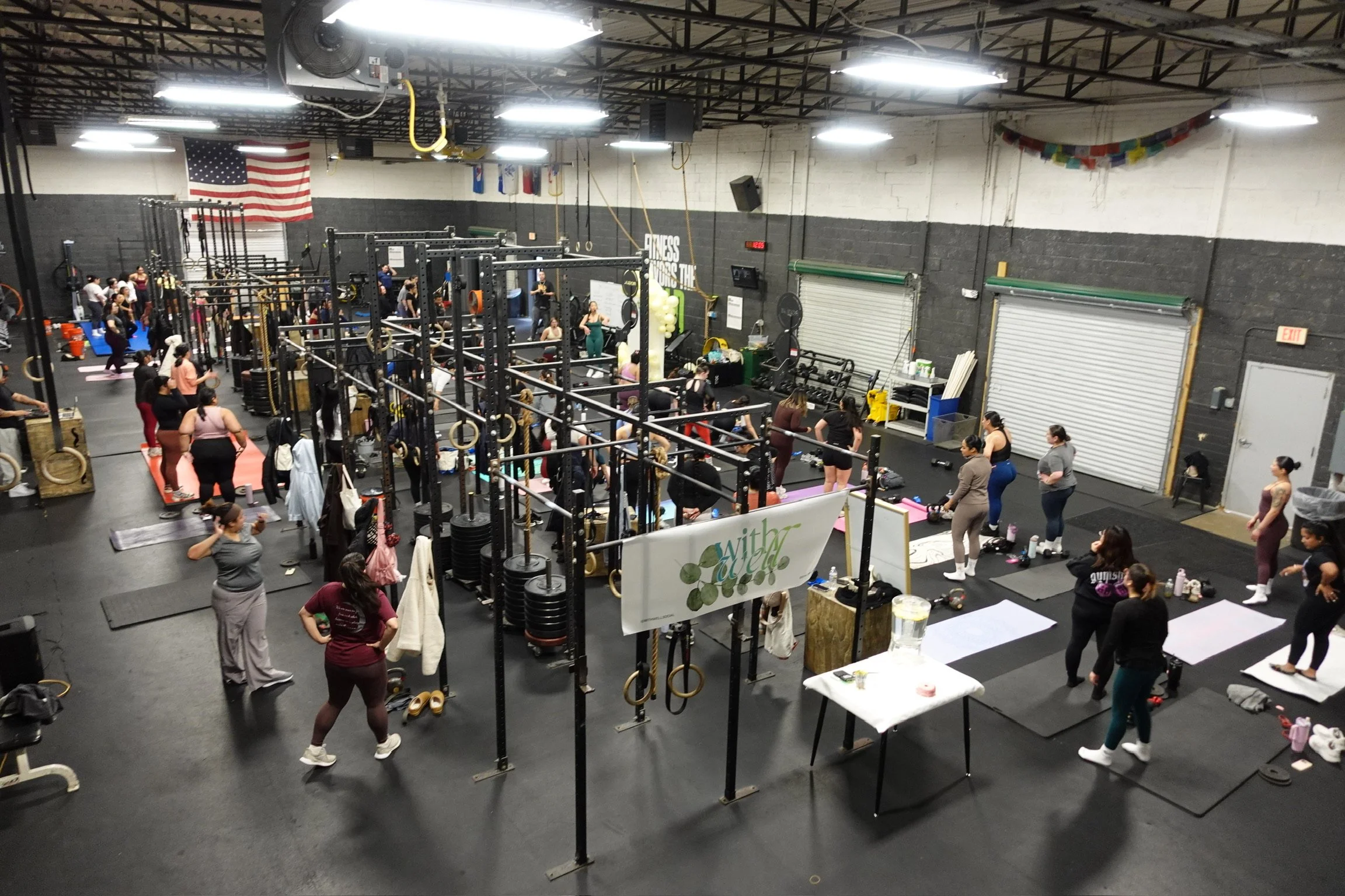 Indoor gym filled with people participating in a group workout class for fitness event Virginia