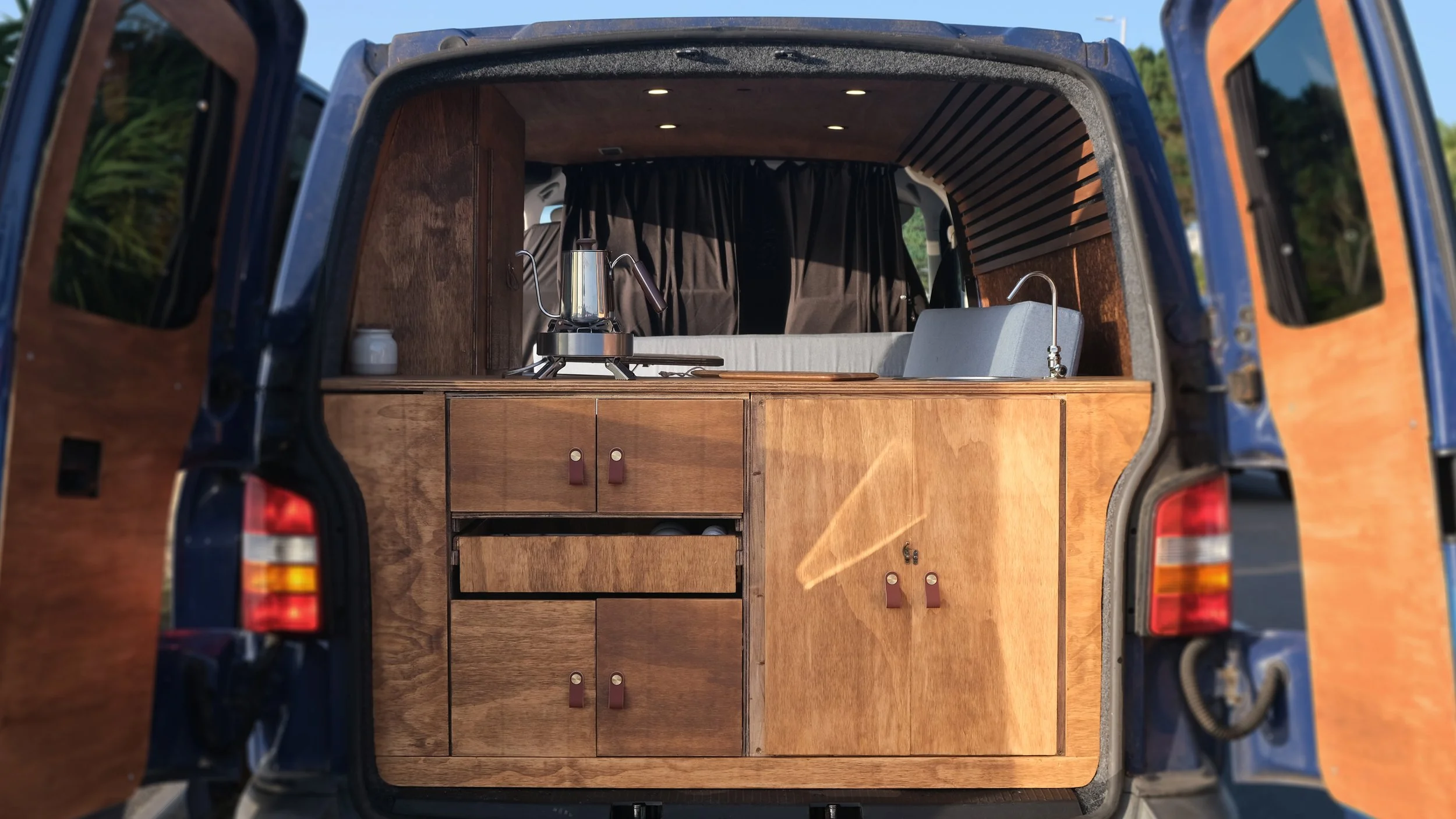 We utilised the rear access for the Cooking Area, this allowed for a more sociable seating area and easier access when handling multiple tasks of a Camp Kitchen. 