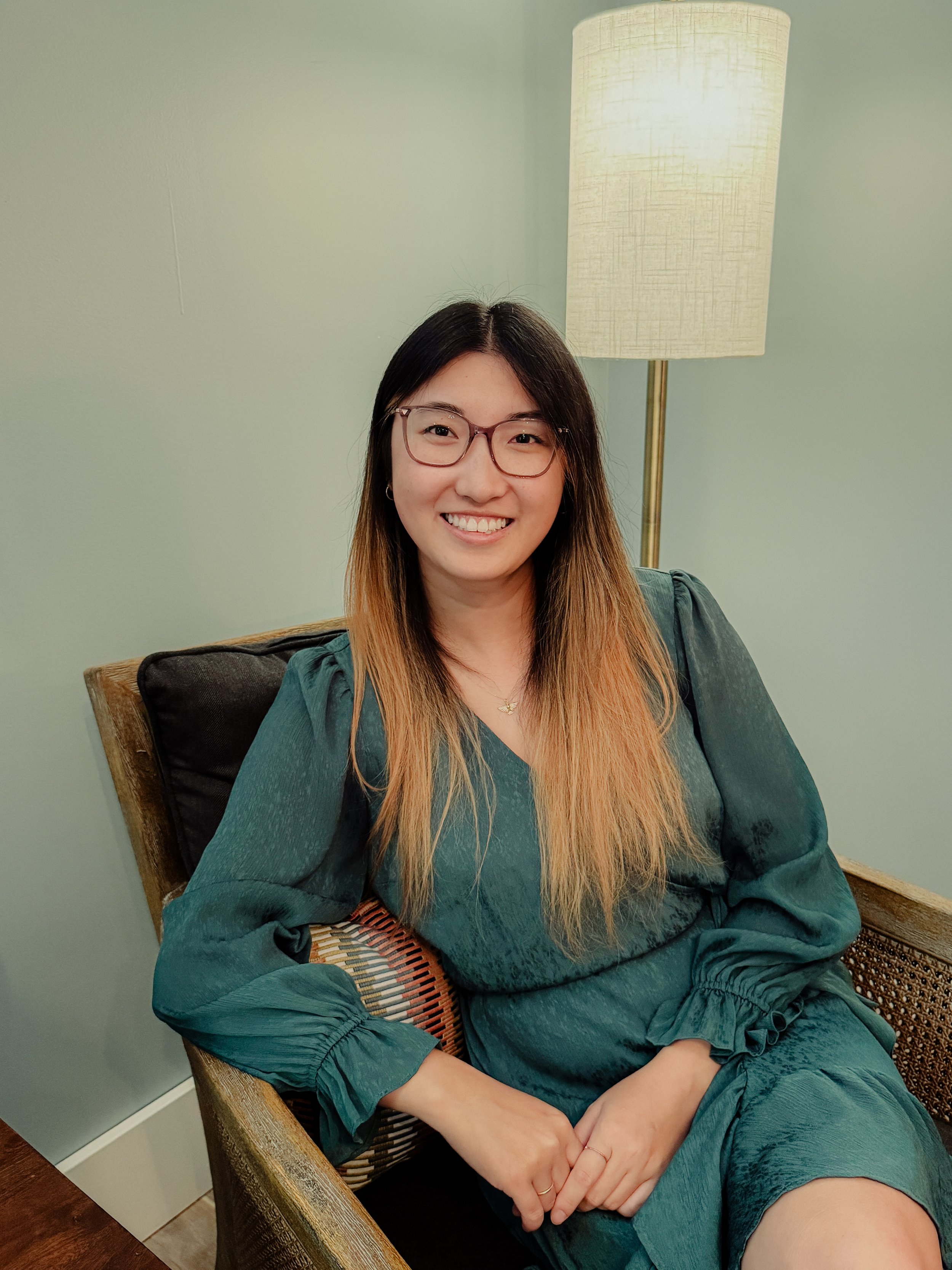 Counselor Clare Beardsley sitting in chair at therapy office in Stillwater, MN