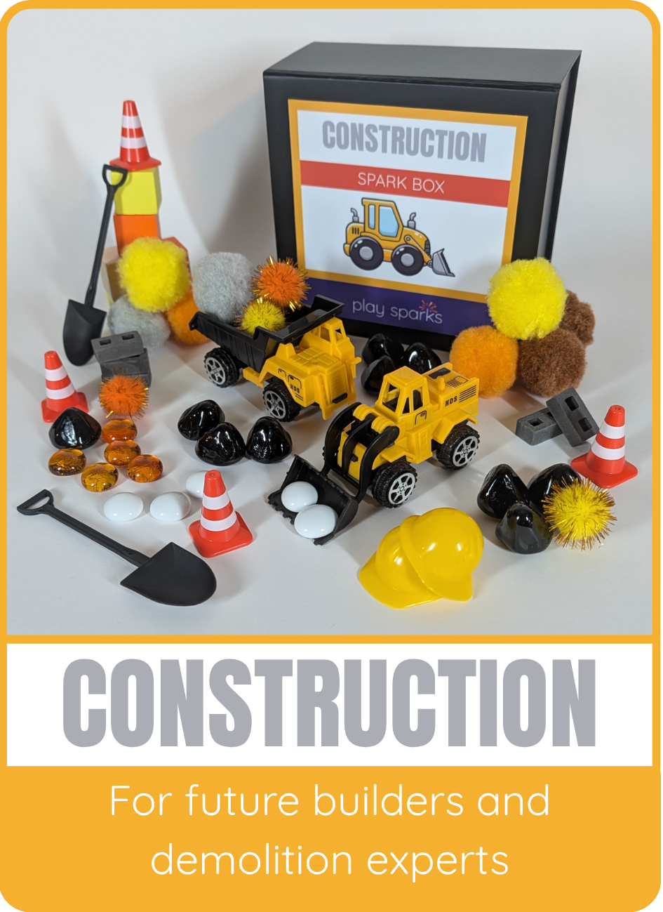Construction Spark Box for future builders and demolition experts, shown with trucks, cones, shovels, and black and amber glass marbles