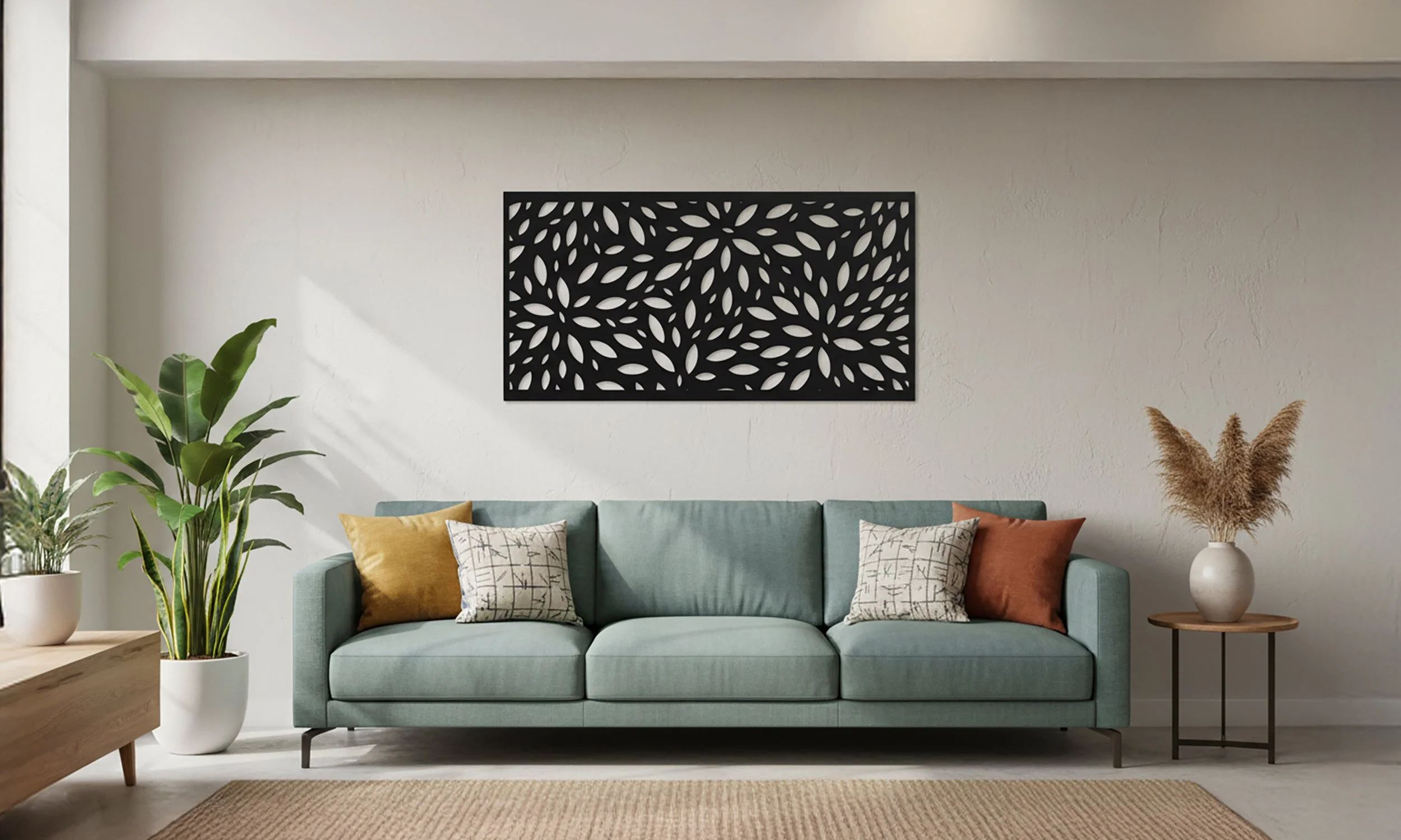 Living room with a light green sofa, decorative pillows, indoor plants, a black wall art piece, and a vase with dried pampas grass.
