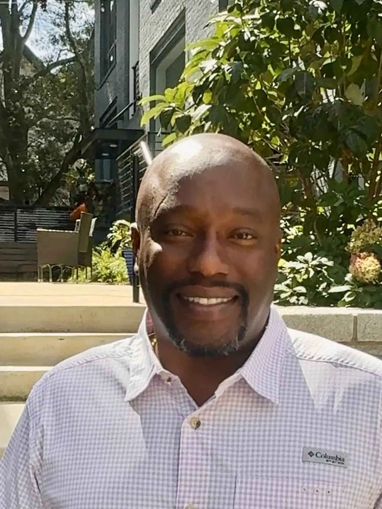 Professional sitting in workspace, looking at laptop screen, focused on planning, strategy, and executing creative business solutions.