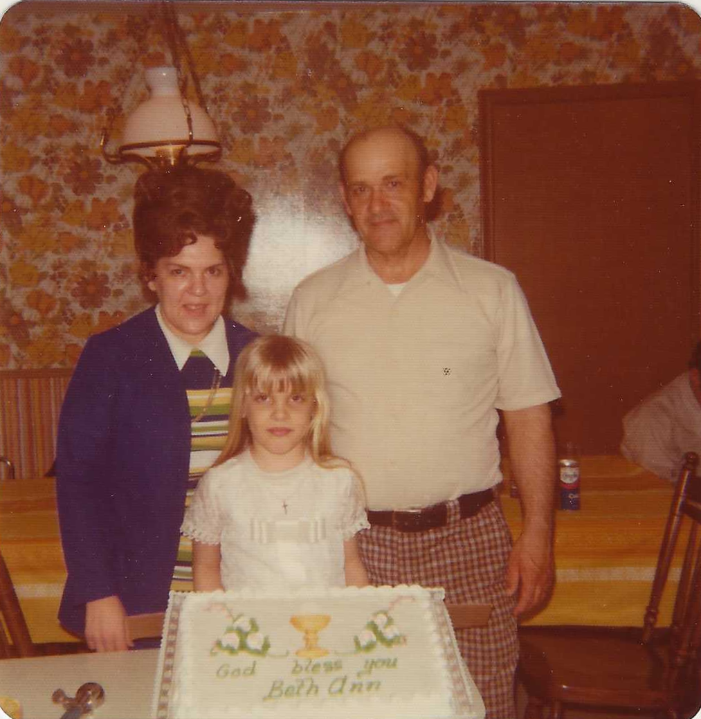 Rita and Frank with Beth First Communion Cake.png