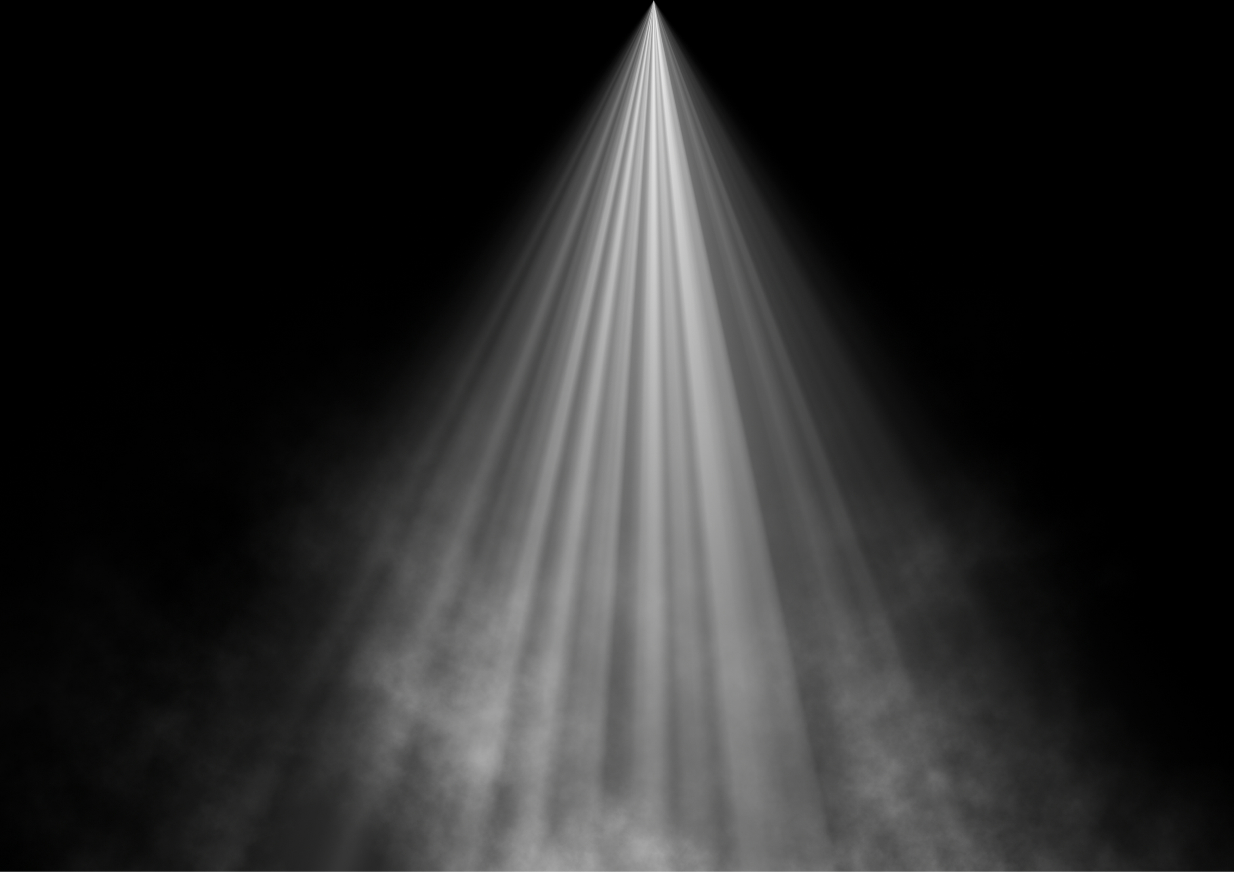 A spotlight shining on a dark stage, illuminating a narrow area.