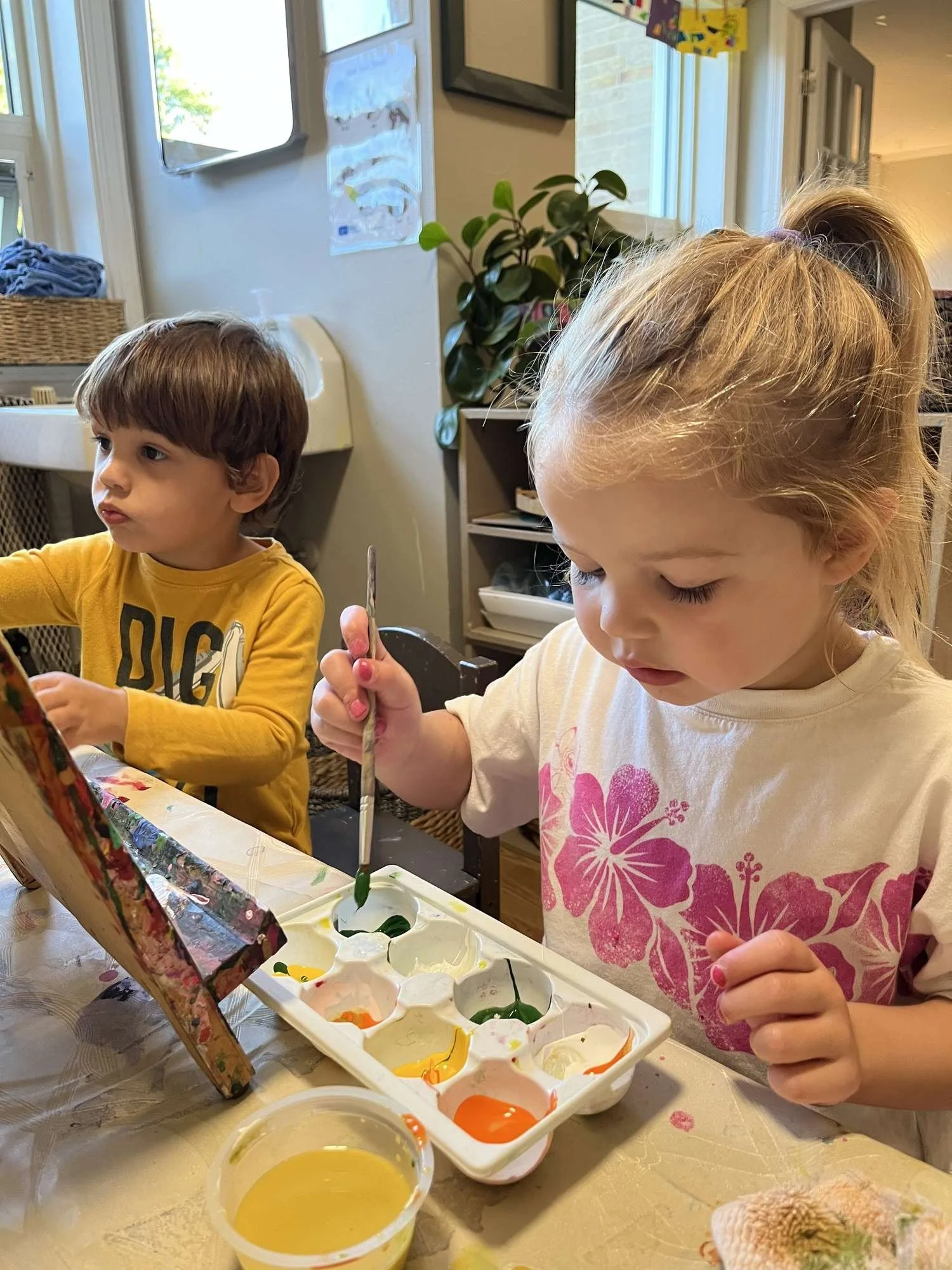 kids painting at an easel