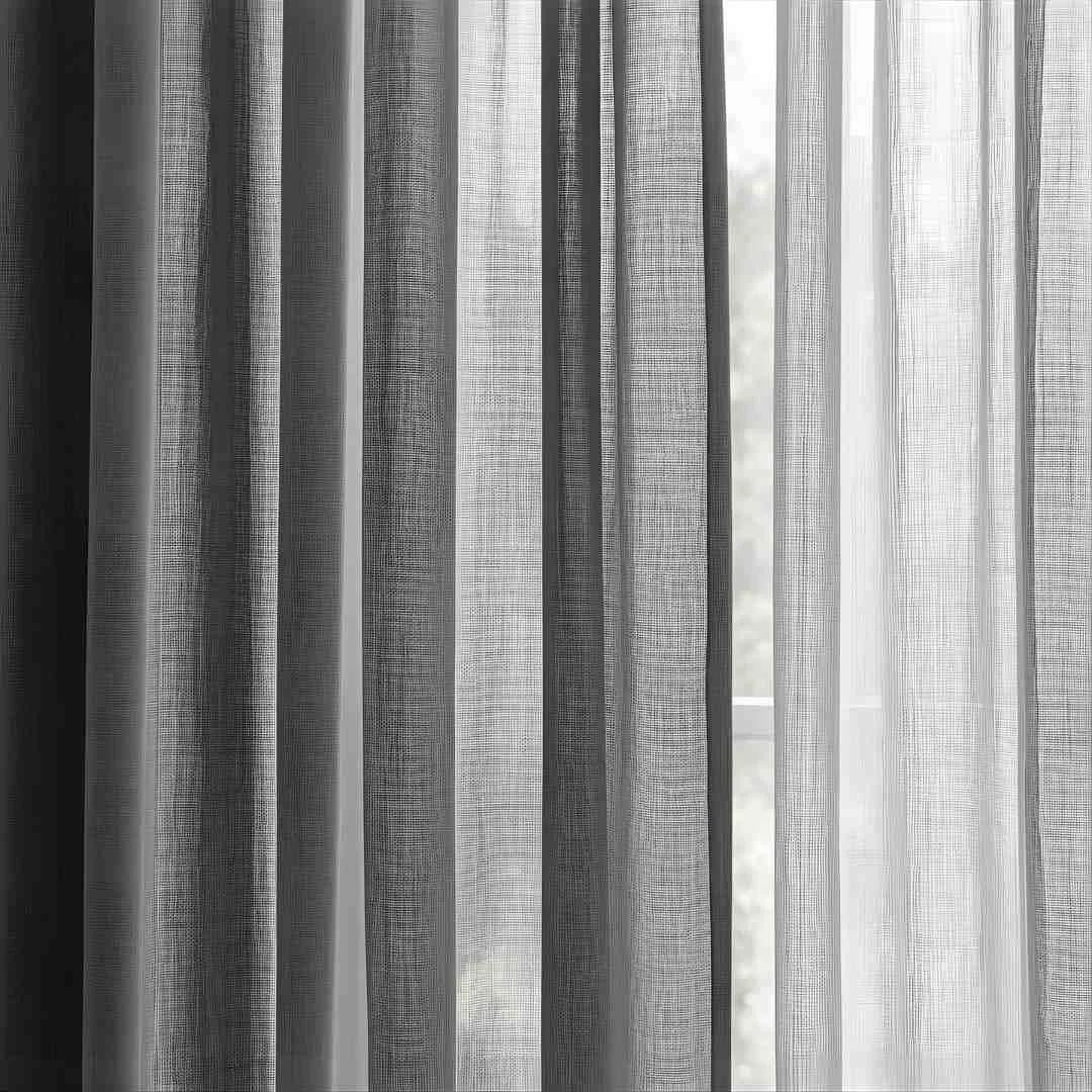 Sheer white curtains hanging in front of a window with natural light coming through.