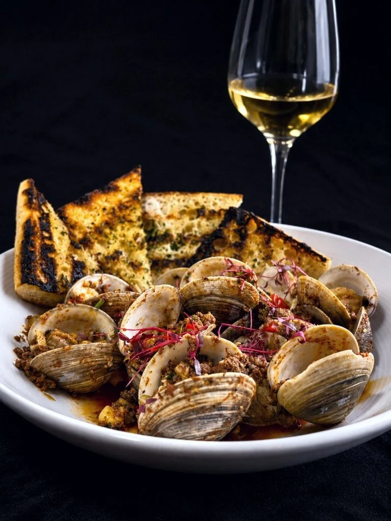 It's all in the details. 

Chef-crafted. Thoughtfully plated. Unforgettable flavors. Tender clams bathed in rich chorizo butter, finished with the delicate elegance of saffron. From kitchen to table, every dish is prepared with precision, creativity,