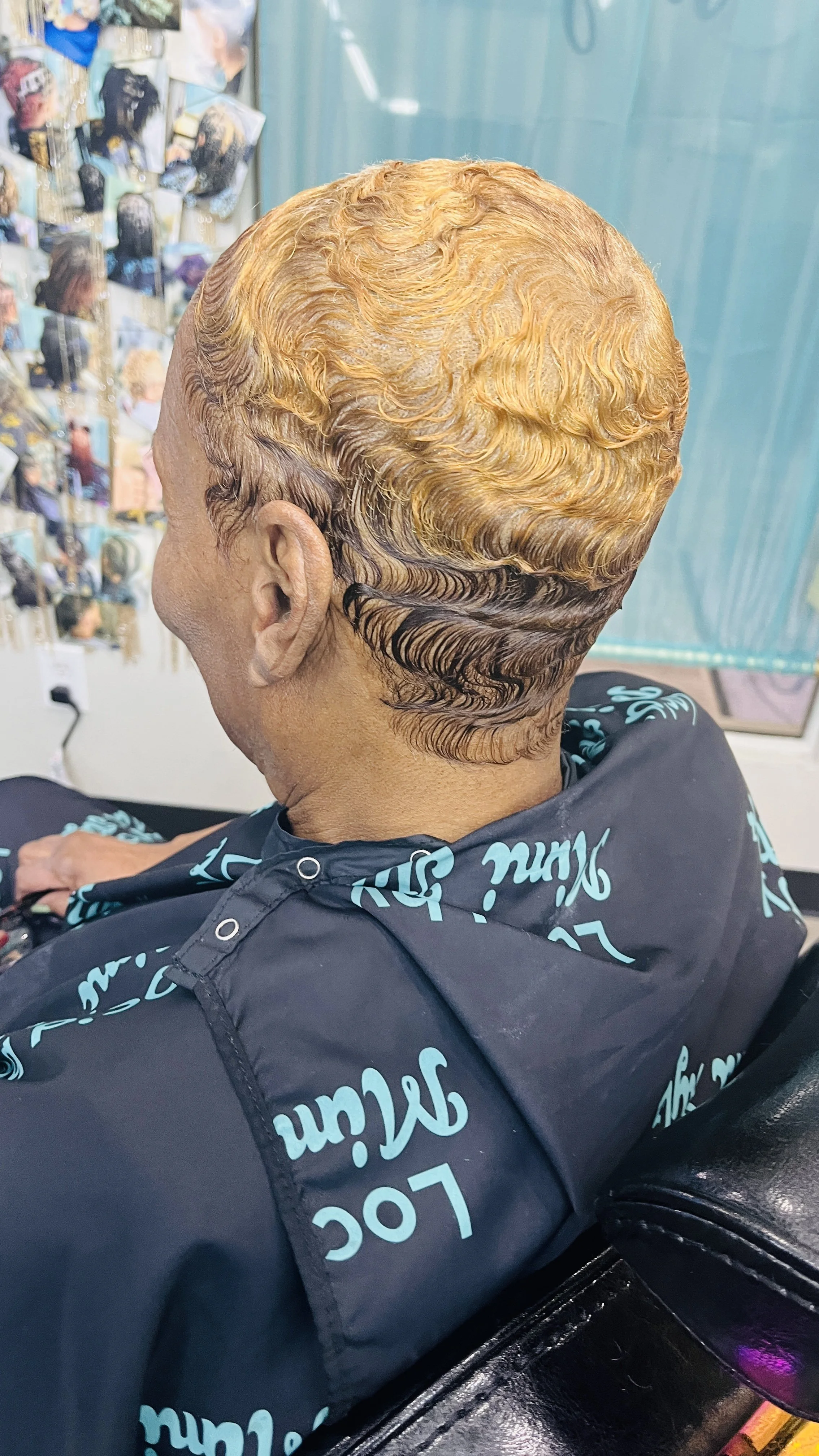 Close-up of a woman with short, two tone finger waved hair done at The Thairapy Suite