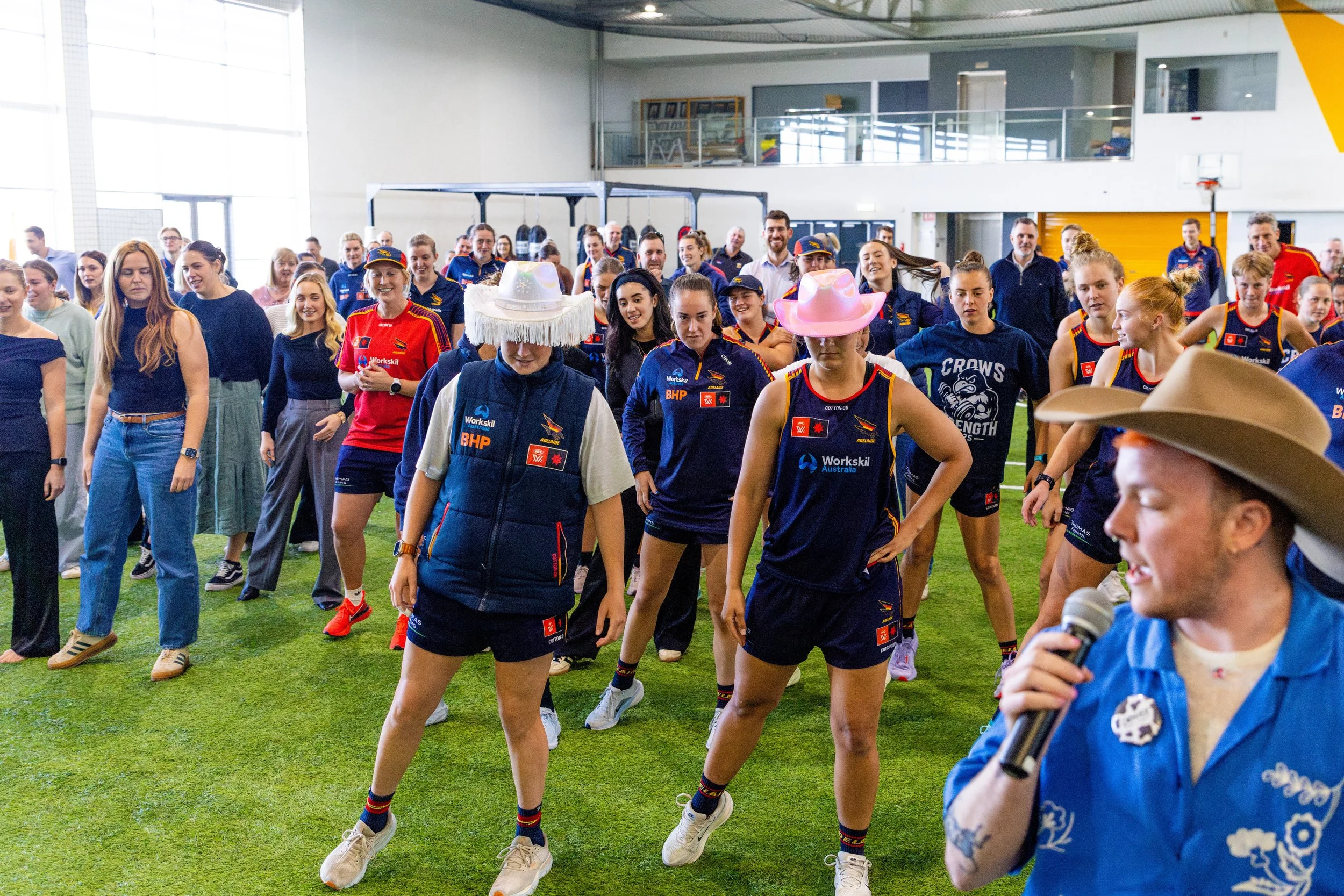 Denver teaching line dancing to the womens' AFL team Adelaide Crows