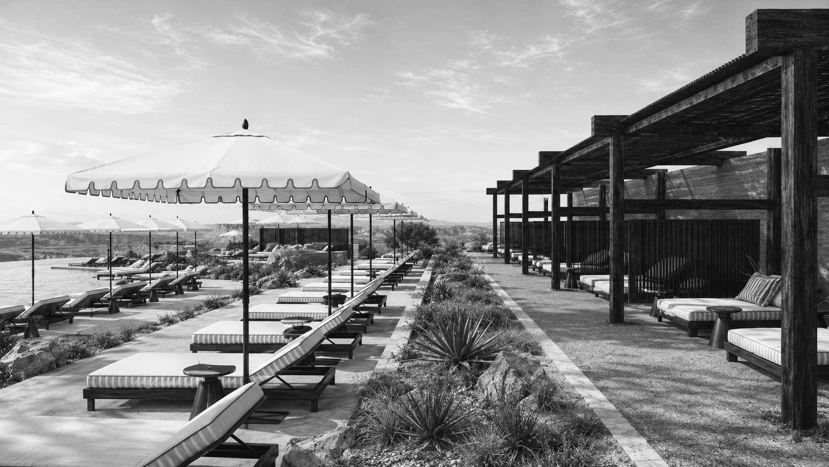 Black and white view of a desert resort walkway lined with shaded pavilions