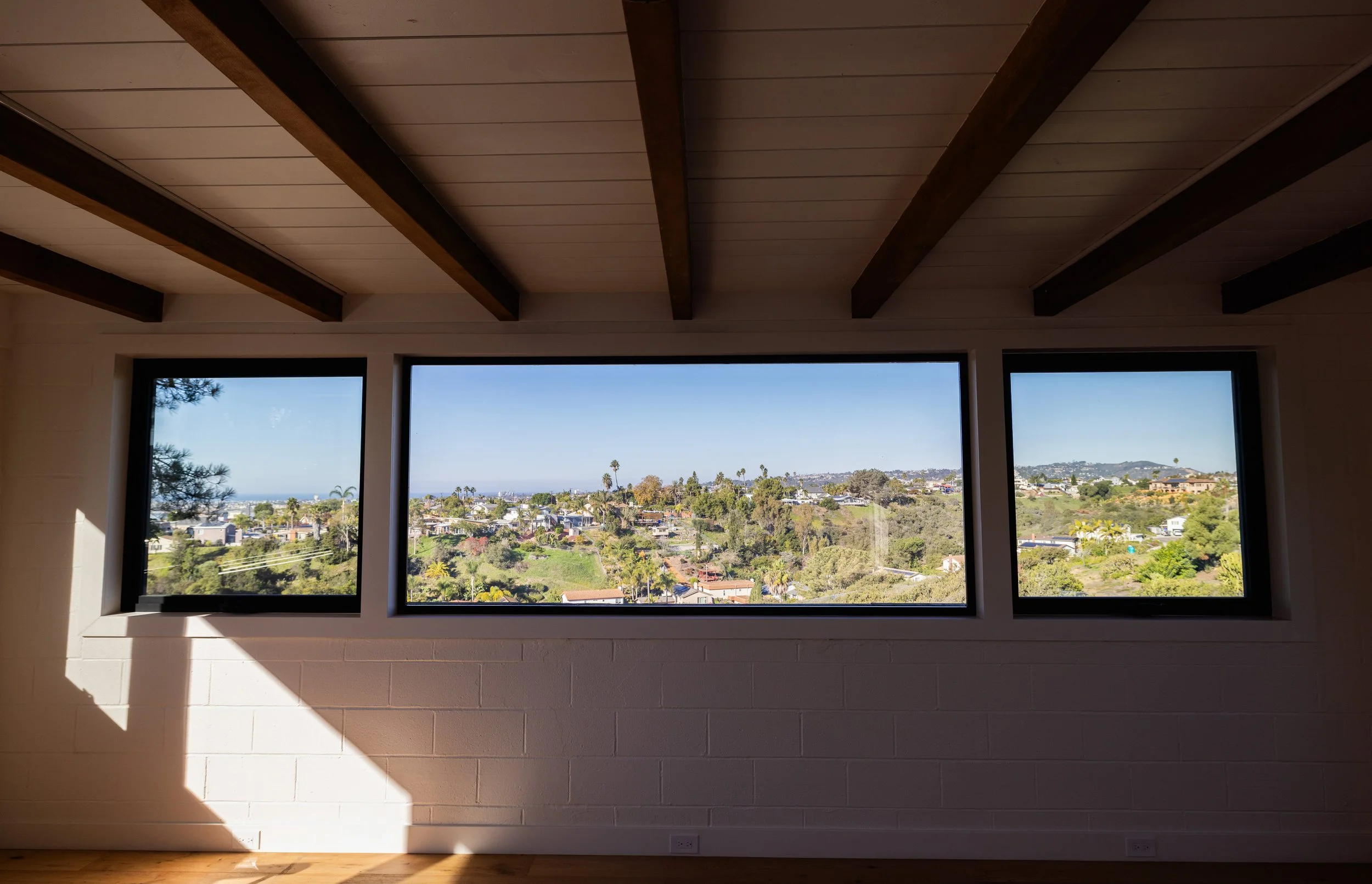 Newly remodeled living room area with sweeping views of San Diego beaches and palm trees in hilly beautiful sunny neighborhood