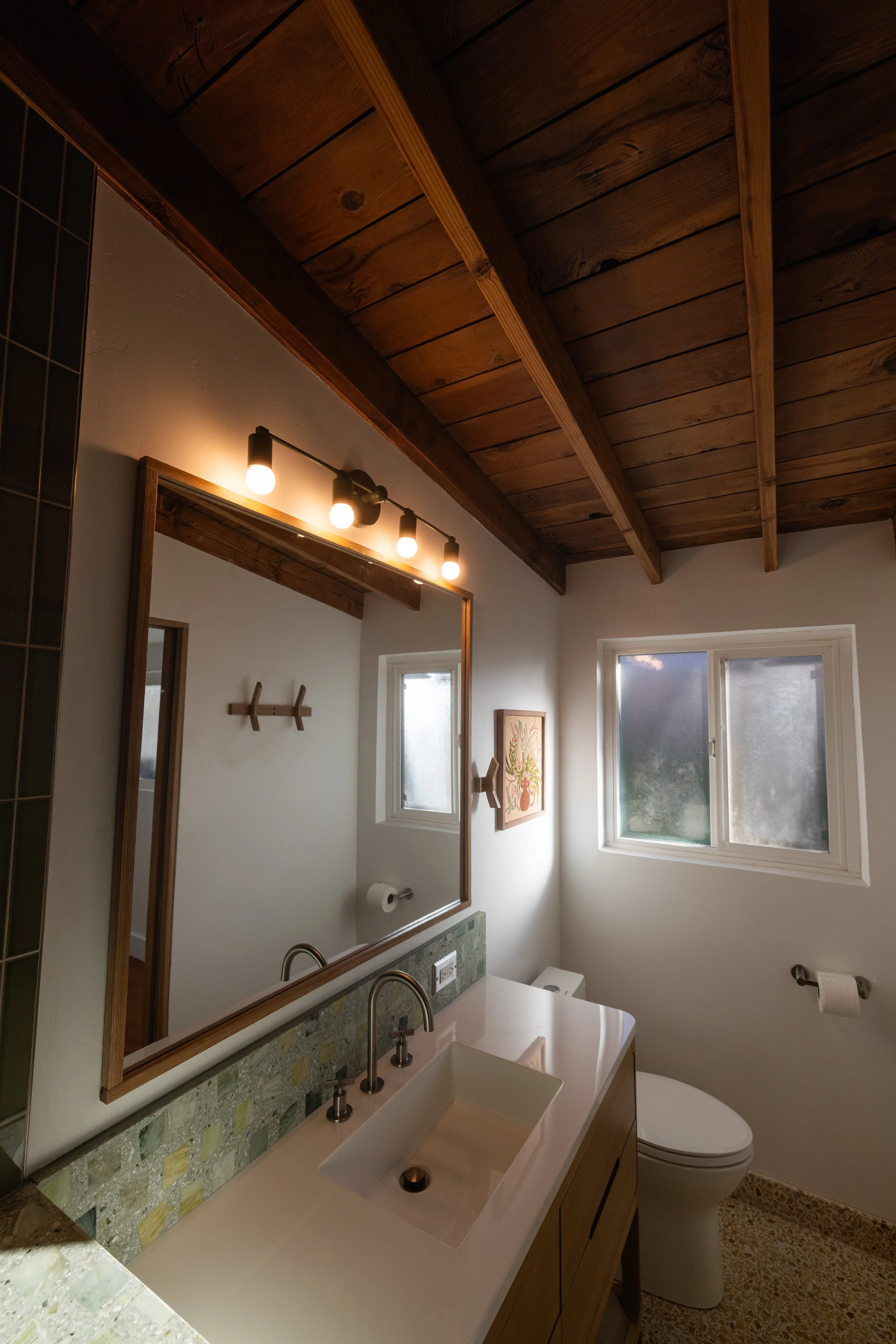 Concrete Collaborative flooring, and backsplash providing texture and color to this mid century modern bathroom designed by Geis Architecture. Luxury high end bathroom design