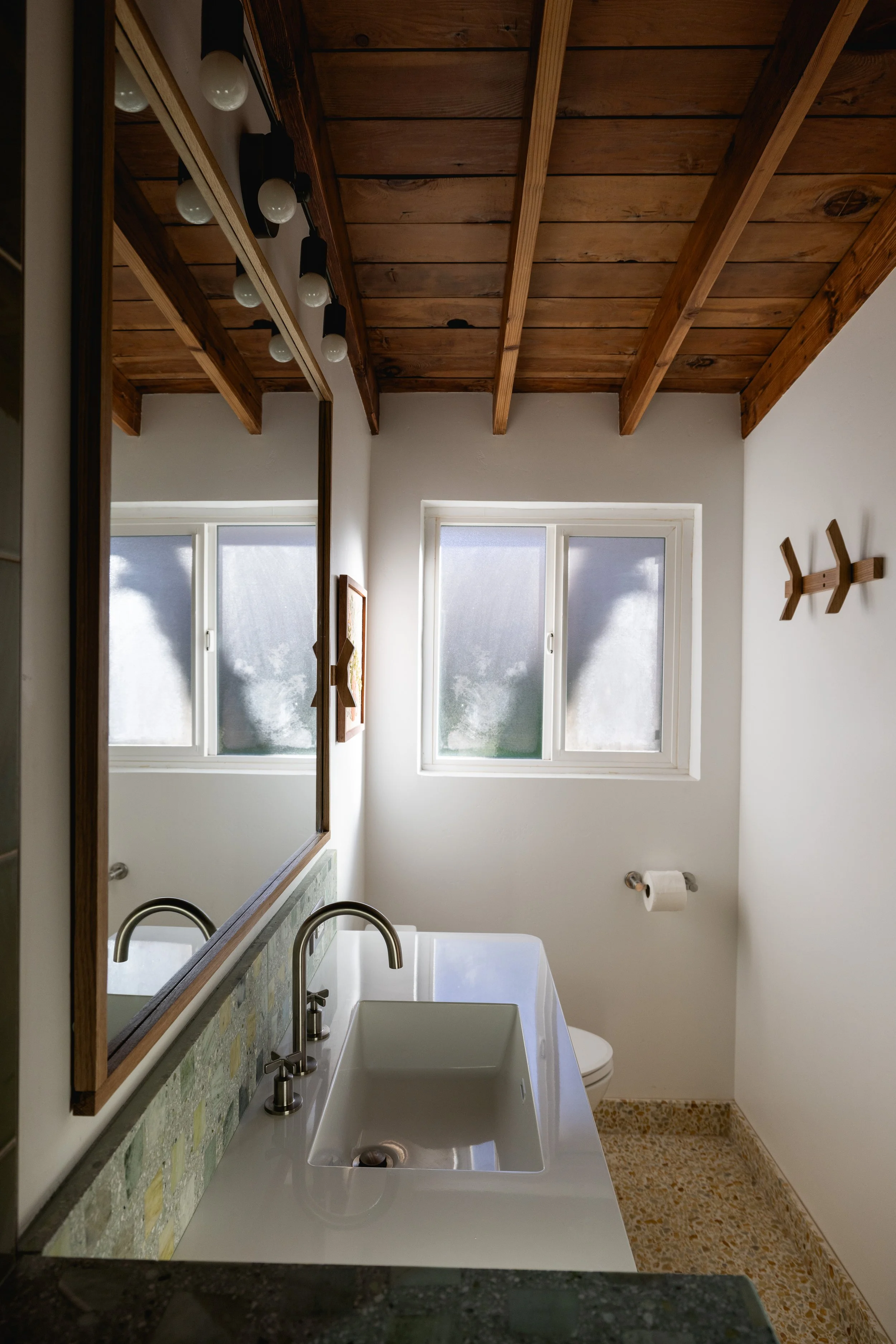 Concrete Collaborative flooring, and backsplash providing texture and color to this mid century modern bathroom designed by Geis Architecture. Luxury high end bathroom design