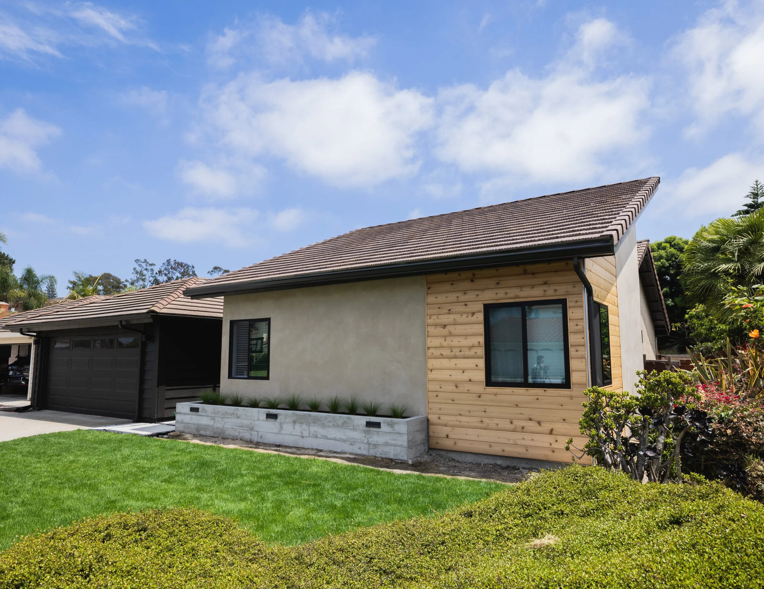 Angeled exterior shot of newly remodeled home in Carlsbad California designed by Geis Architecture. Modern, sleek, smooth stucco